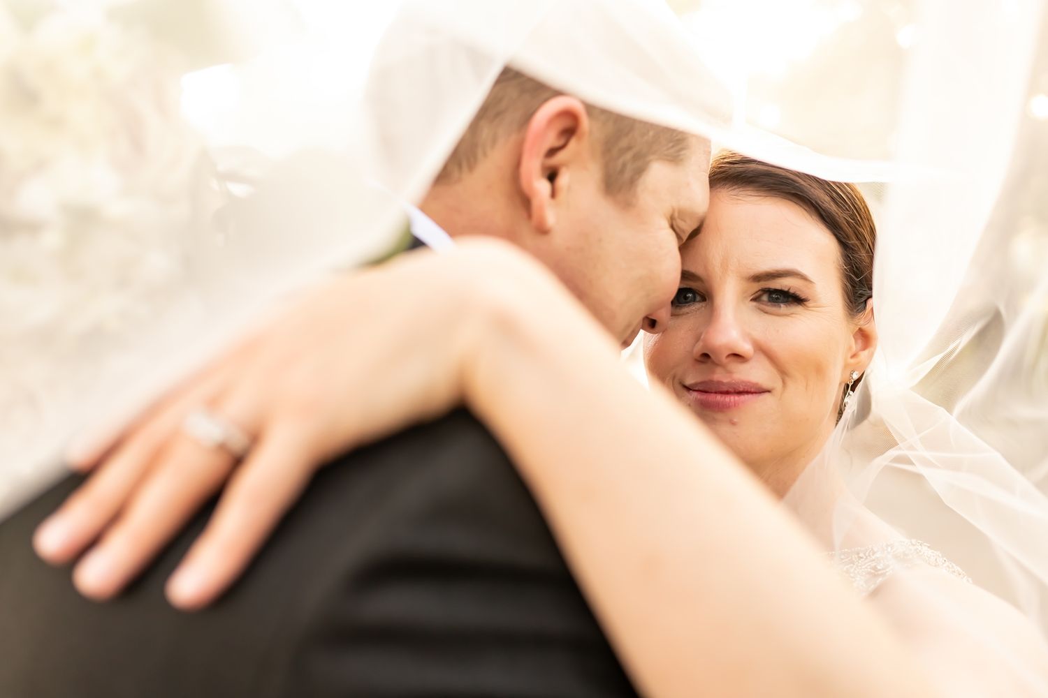 Intimate wedding photography series captures tender moments between newlyweds in soft natural light.