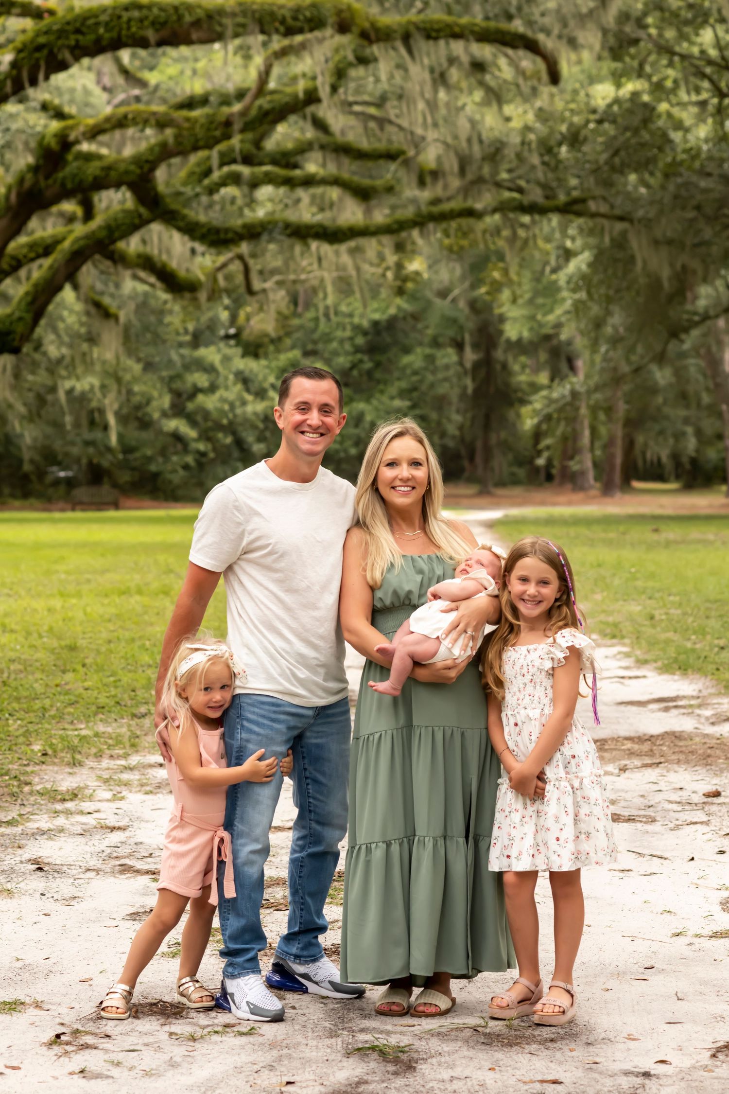 Family portrait under moss-draped oak trees in a Southern park landscape on Hilton Head Island.