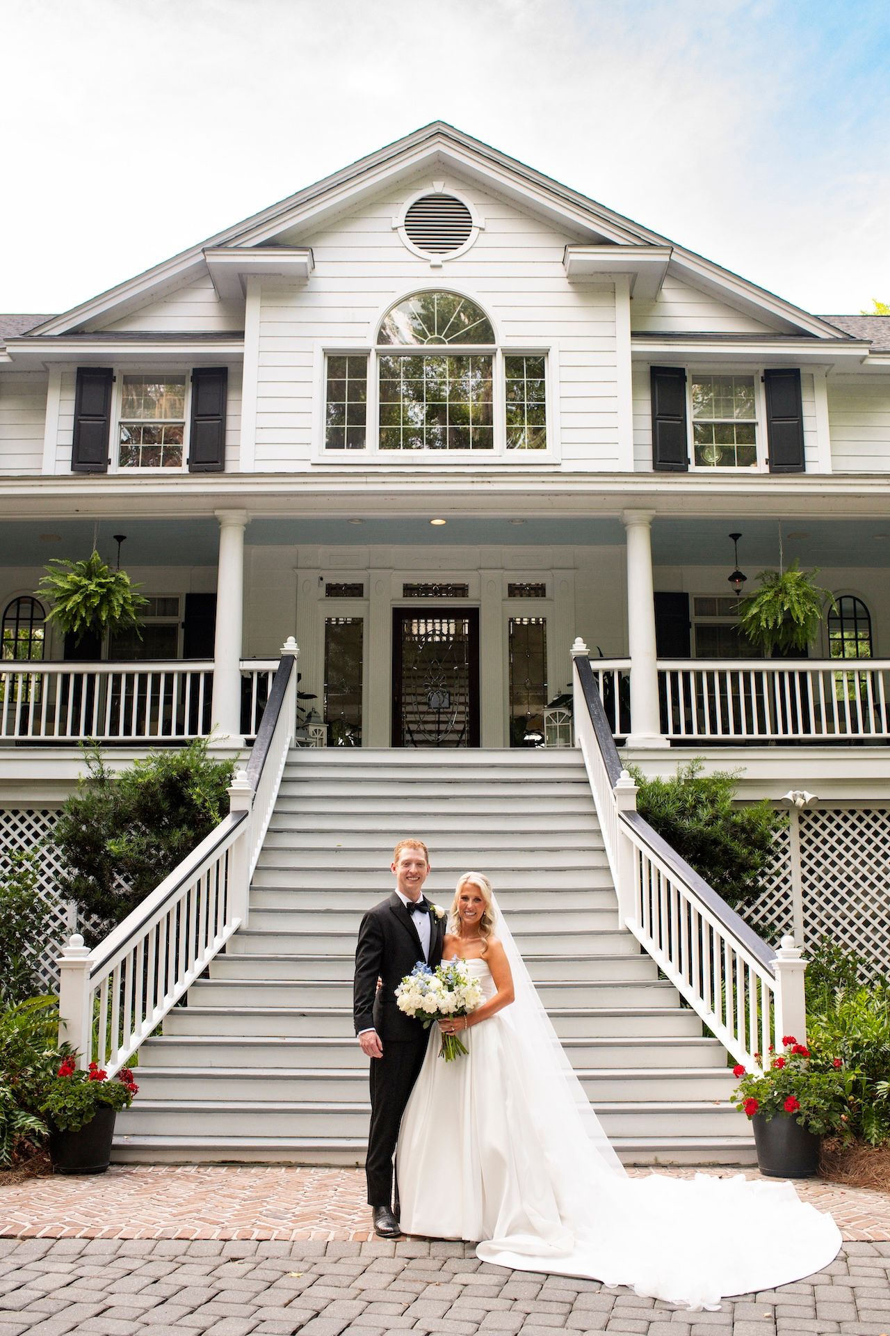 Bride and groom portraits in front of The Mackey House estate and front porch.