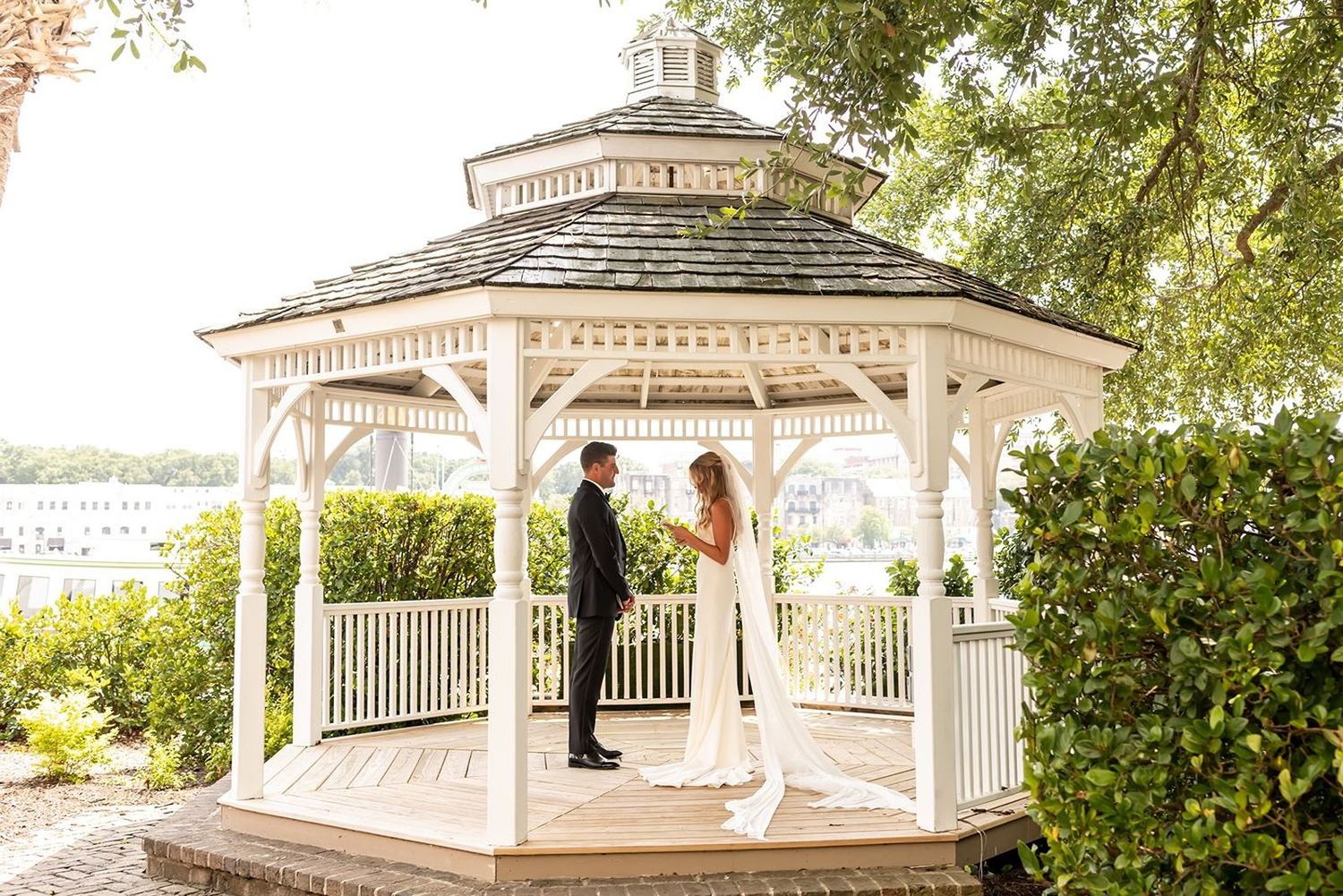Bride & Groom exchange private vows in gazebo overlooking a marina