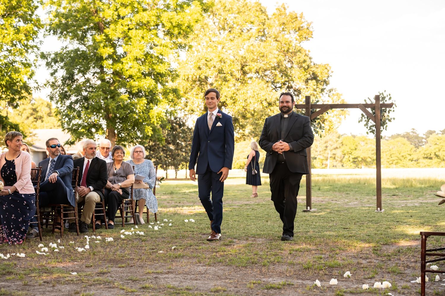 Outdoor autumn wedding ceremony photos captured in sequence with guests seated under golden trees in a park.