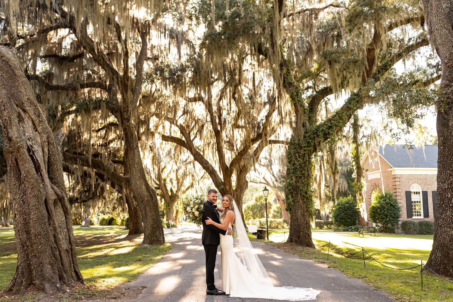A gorgeous tree-lined avenue with Spanish moss hanging from live oak branches creates a romantic walkway.