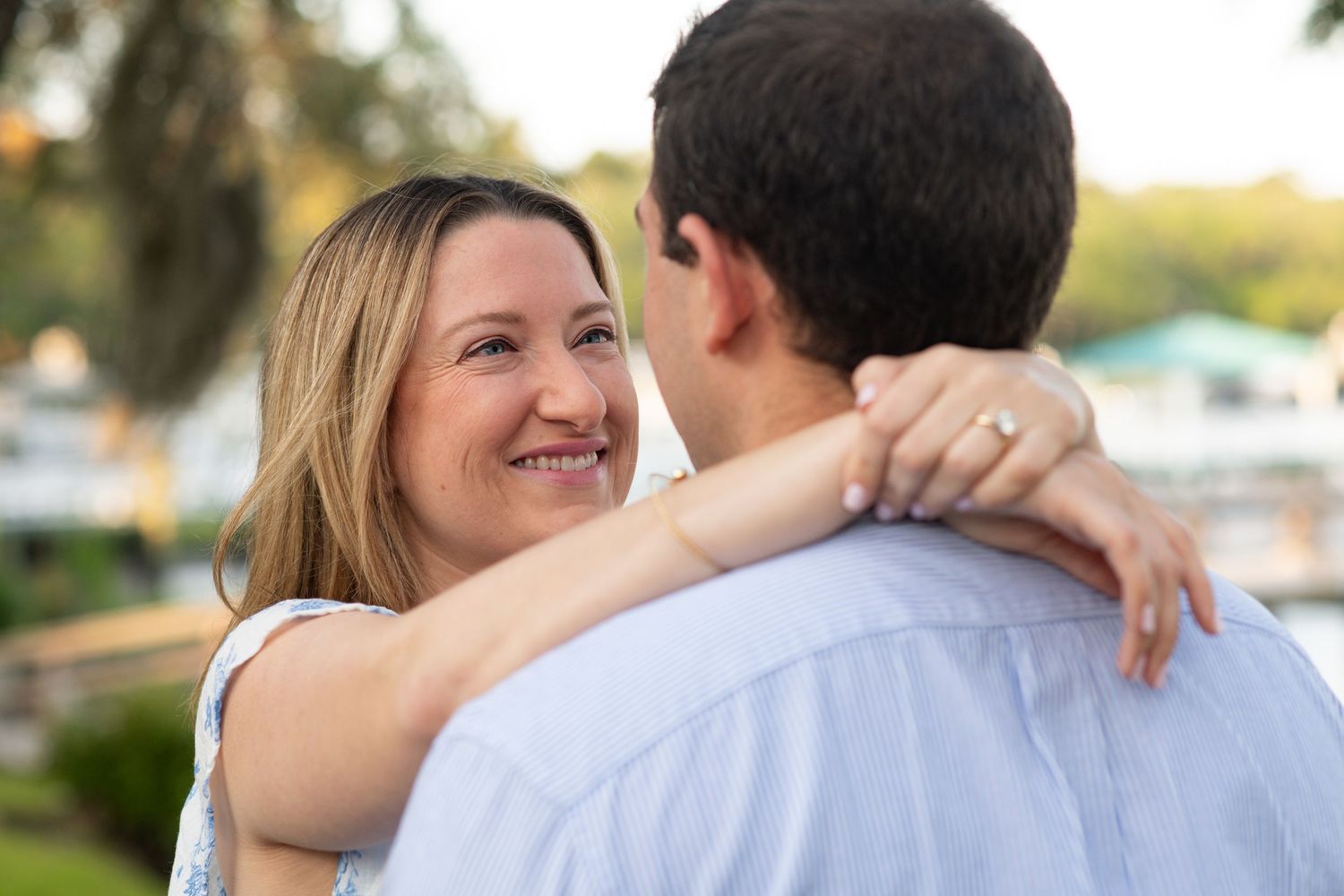 A couple embraces on the bluff at their Isle of Hope engagement session