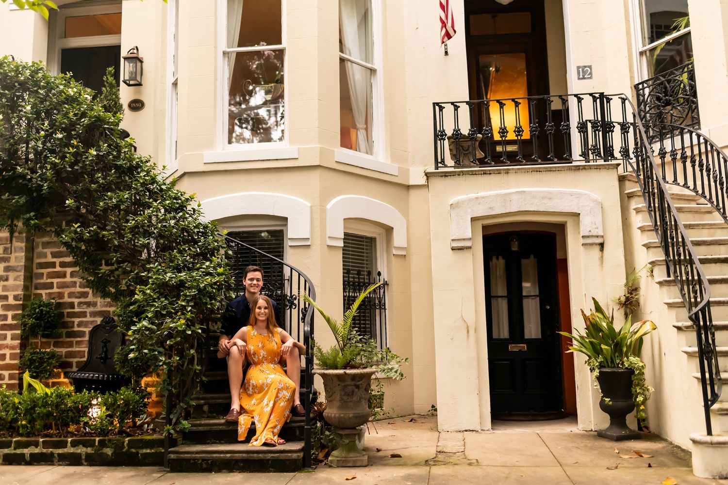 A row of historic brownstone townhouses in a residential neighborhood showing architectural details and entry stairs.