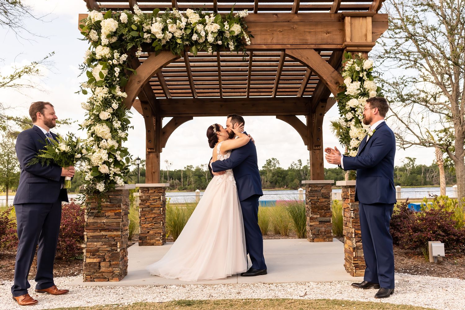 A wedding couple shares intimate moments under wooden pergolas across multiple romantic outdoor shots.