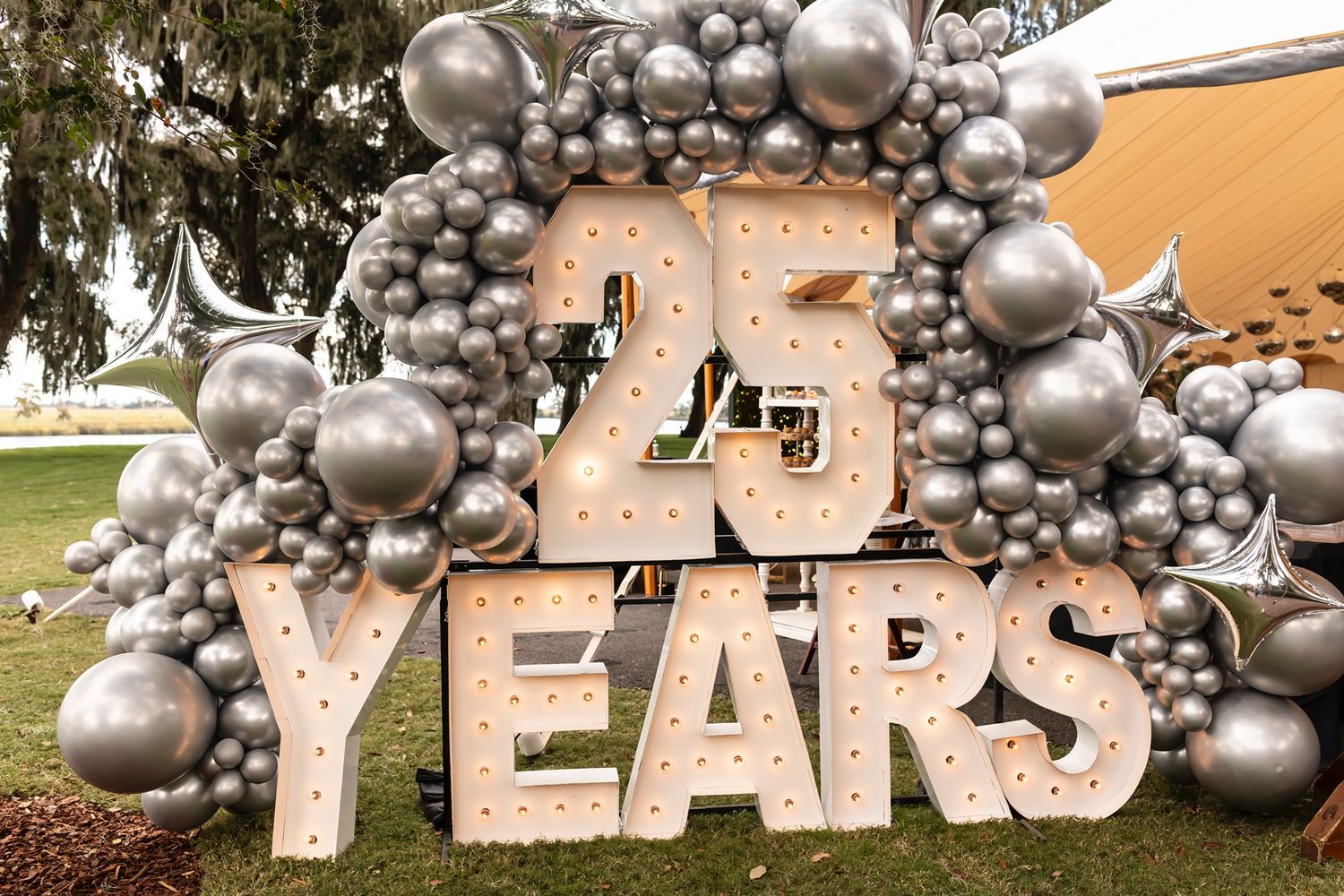 A silver balloon arch with '25 YEARS' text for an anniversary celebration.