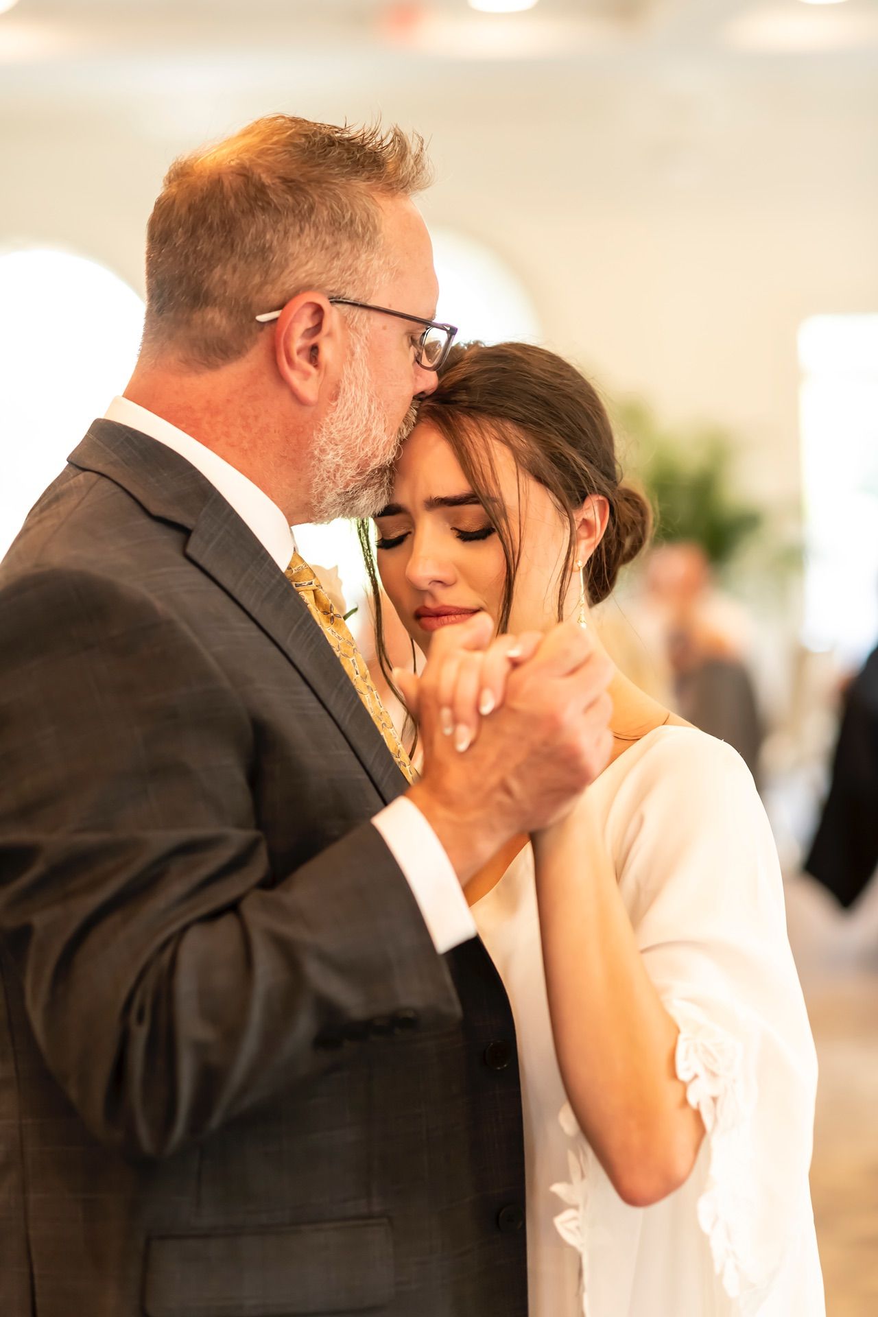 A tender moment between newlyweds as they share their first dance at their wedding reception.
