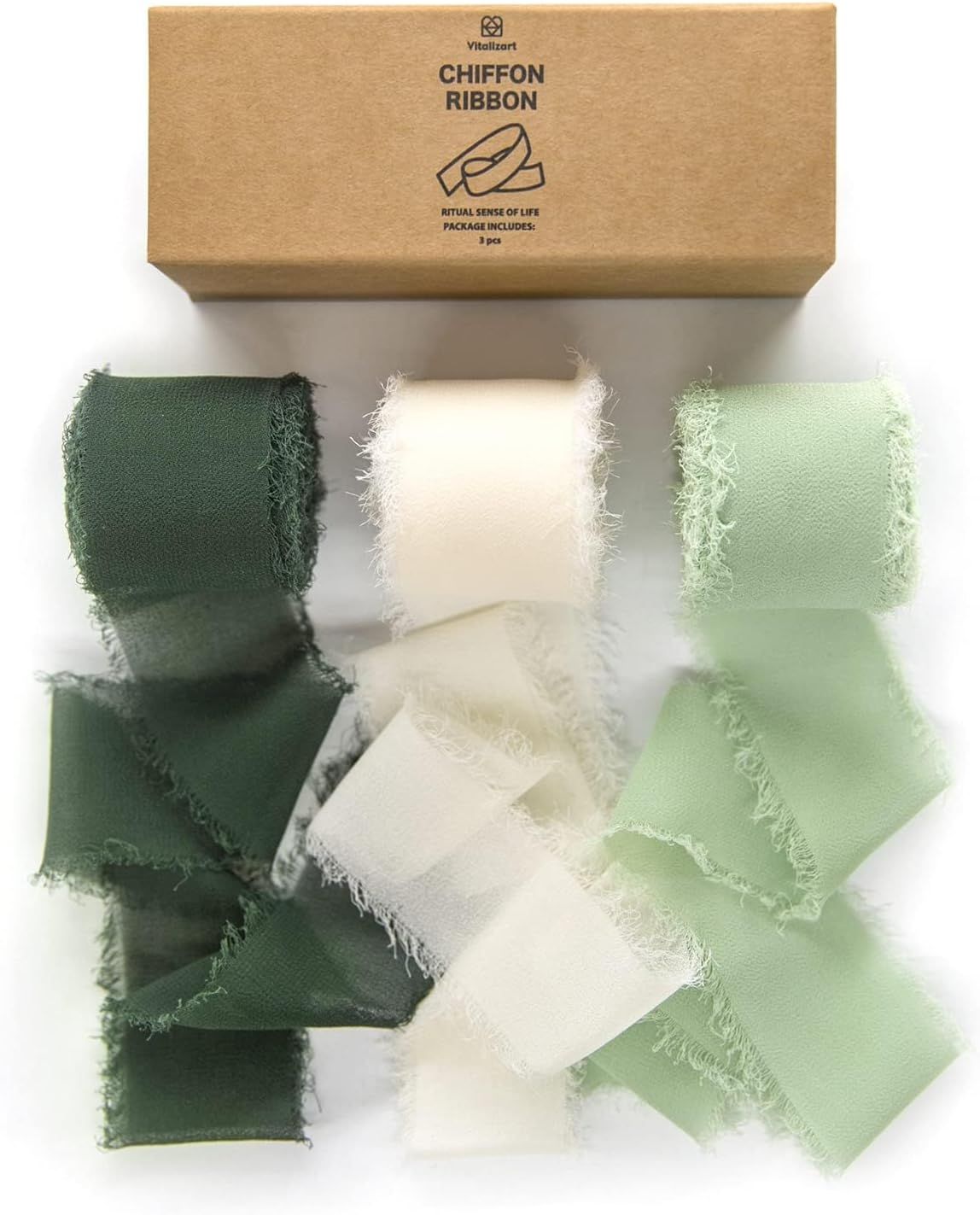 A curated collection of silk ribbon and chiffon fabric swatches in shades of forest green, ivory, and mint.