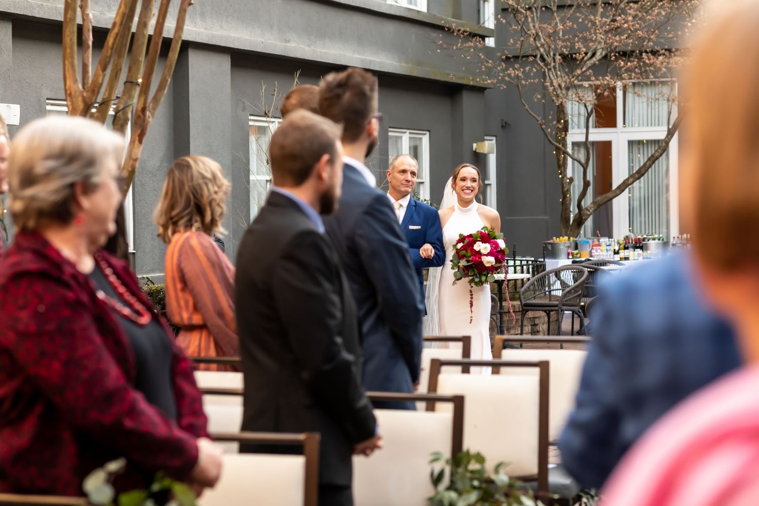 A group of people gathered outdoors on a patio area during what appears to be an event or gathering.