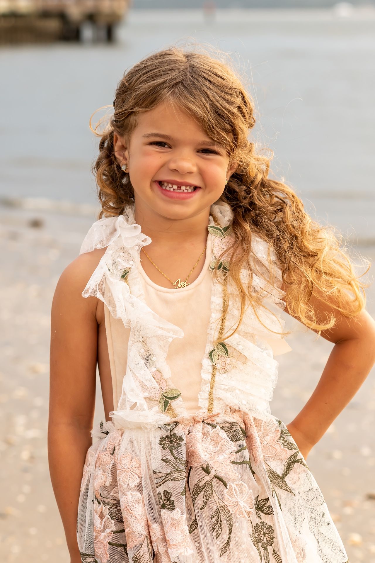 A sequence of progressive images capturing joyful moments on a sunny beach with white lace dress details.