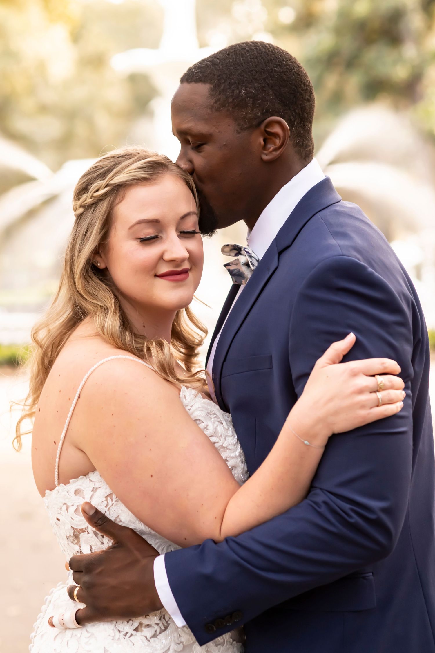 A tender wedding moment captured in a series of intimate embrace photos between newlyweds in a romantic outdoor setting.