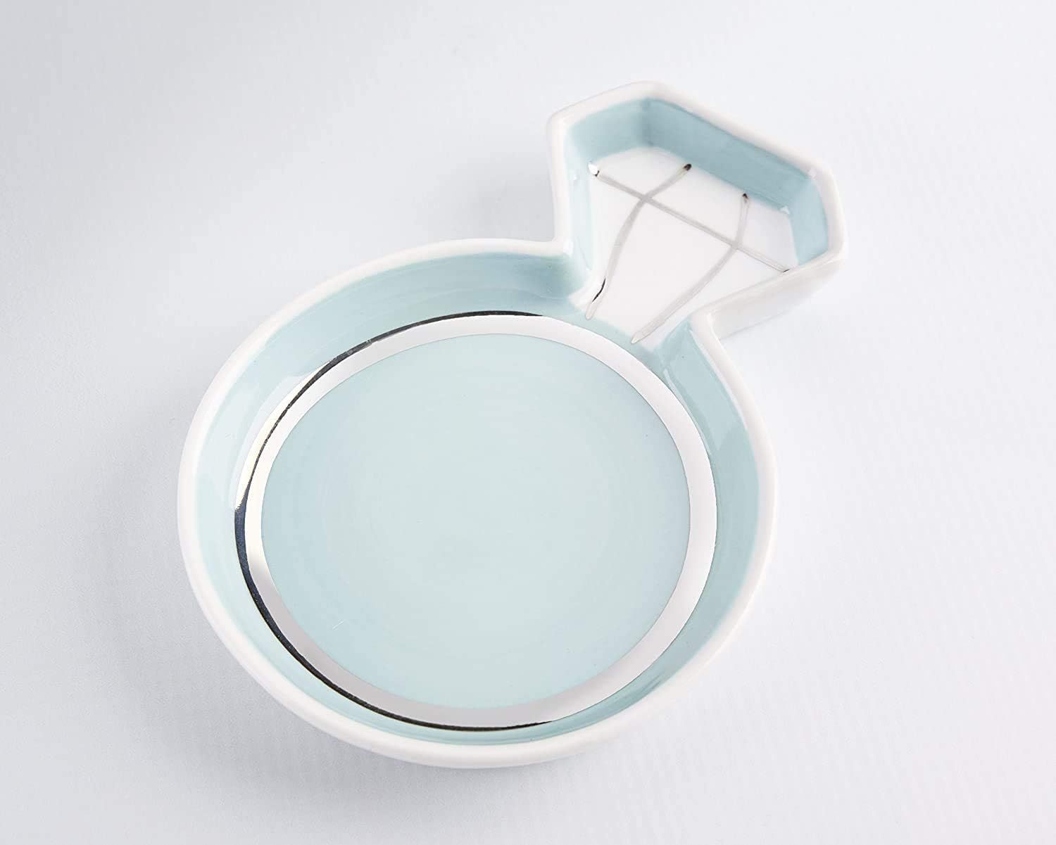 A round white wall-mounted suction mirror with a pivoting arm against a light background.