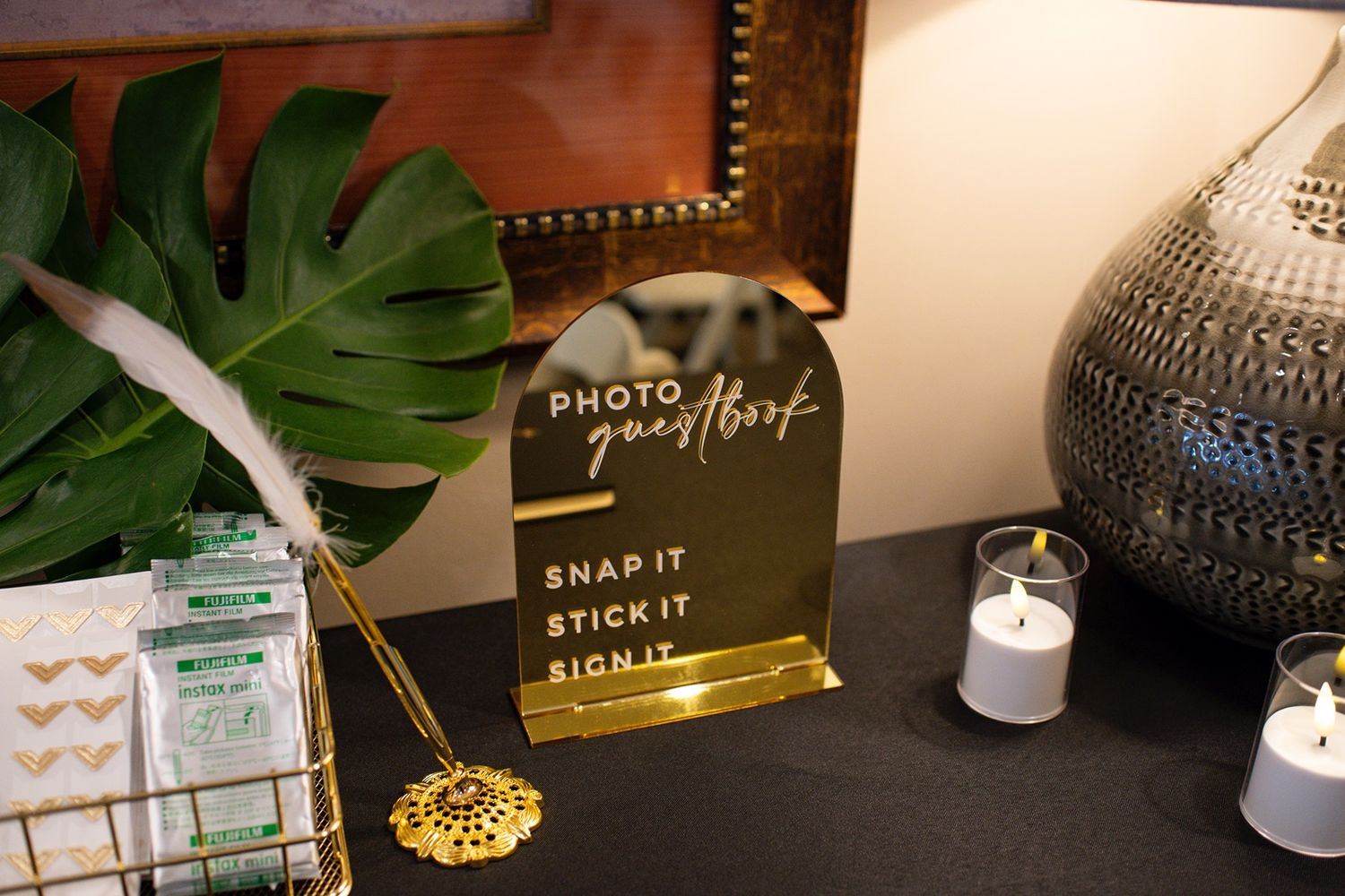 Modern home office workspace with monstera plant, gold decor, and stylish accessories arranged on white desk.