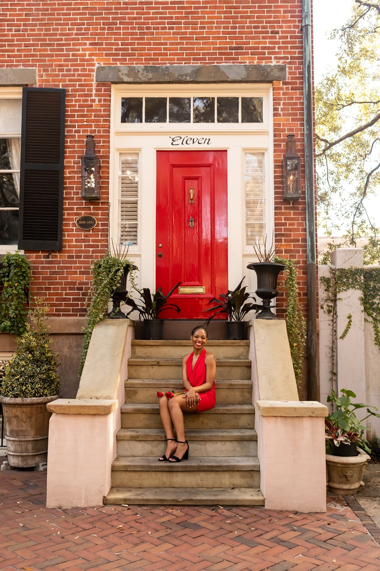 Four sequential photos show red brick townhouse entrances with red doors, stone steps, and black shutters in a historic setting.