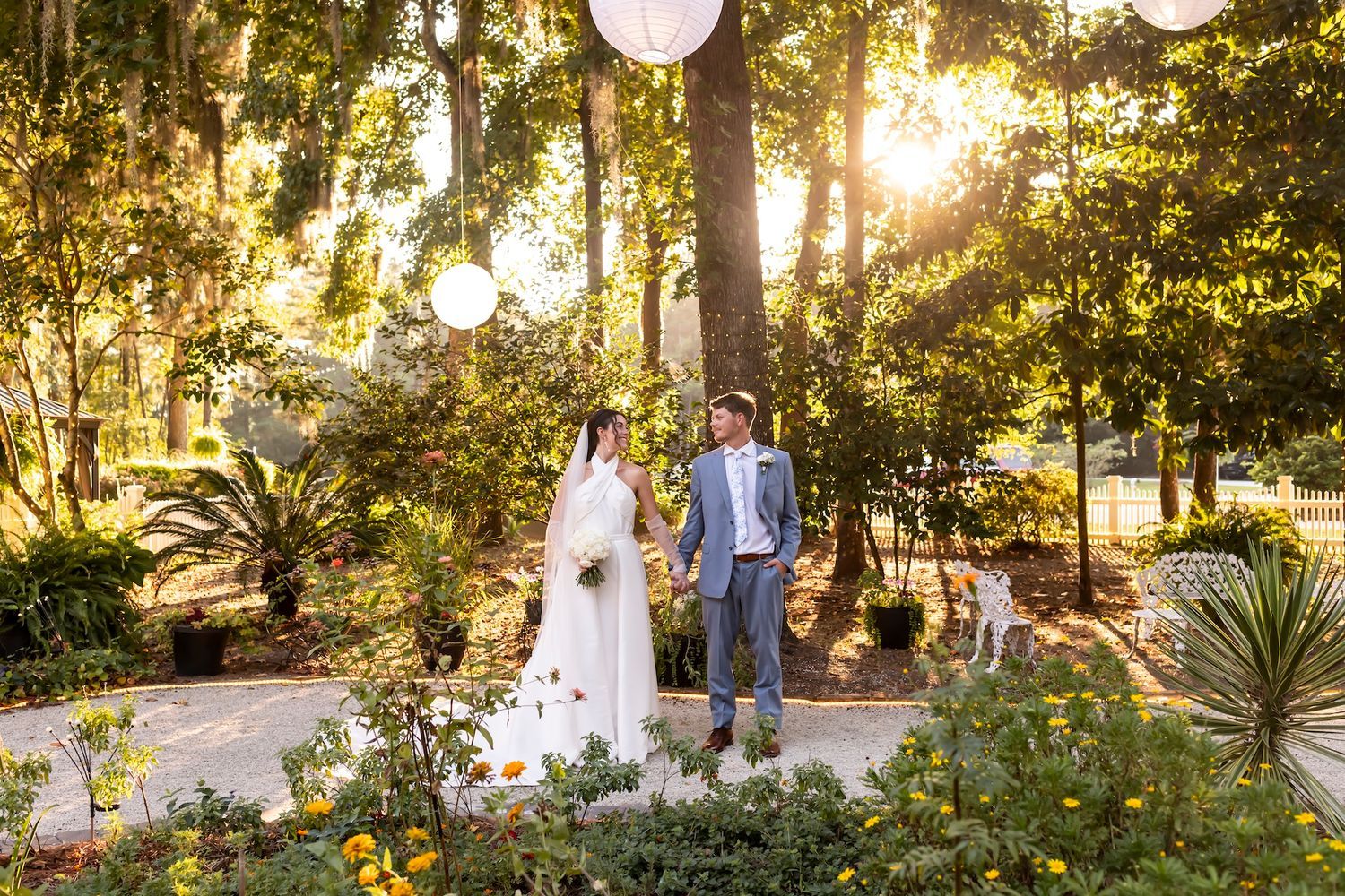 Bride and Groom posing in The Mackey House gardens at sunset in
