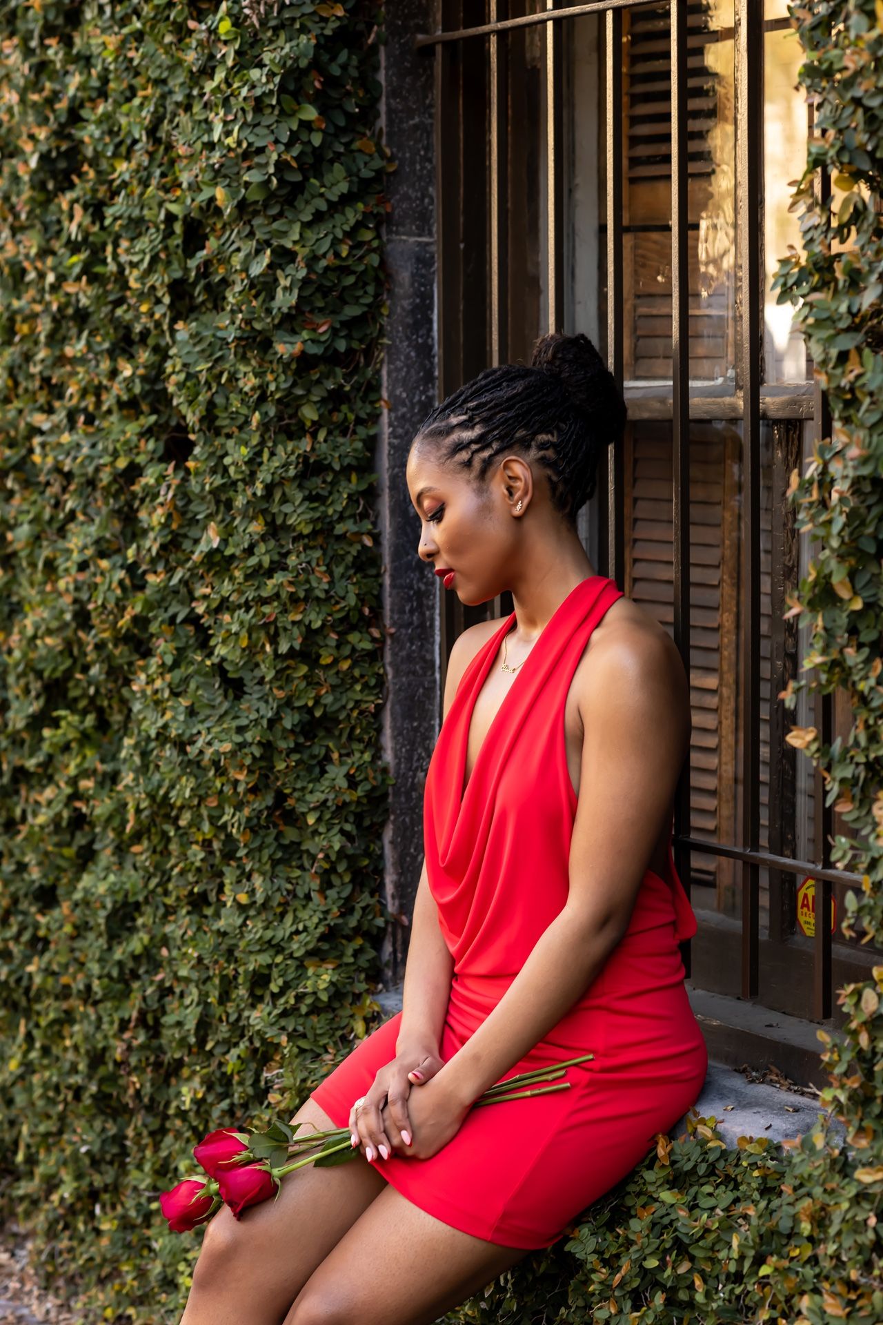 A sequence of contemplative poses on a bench with ivy-covered walls and windows in the background.
