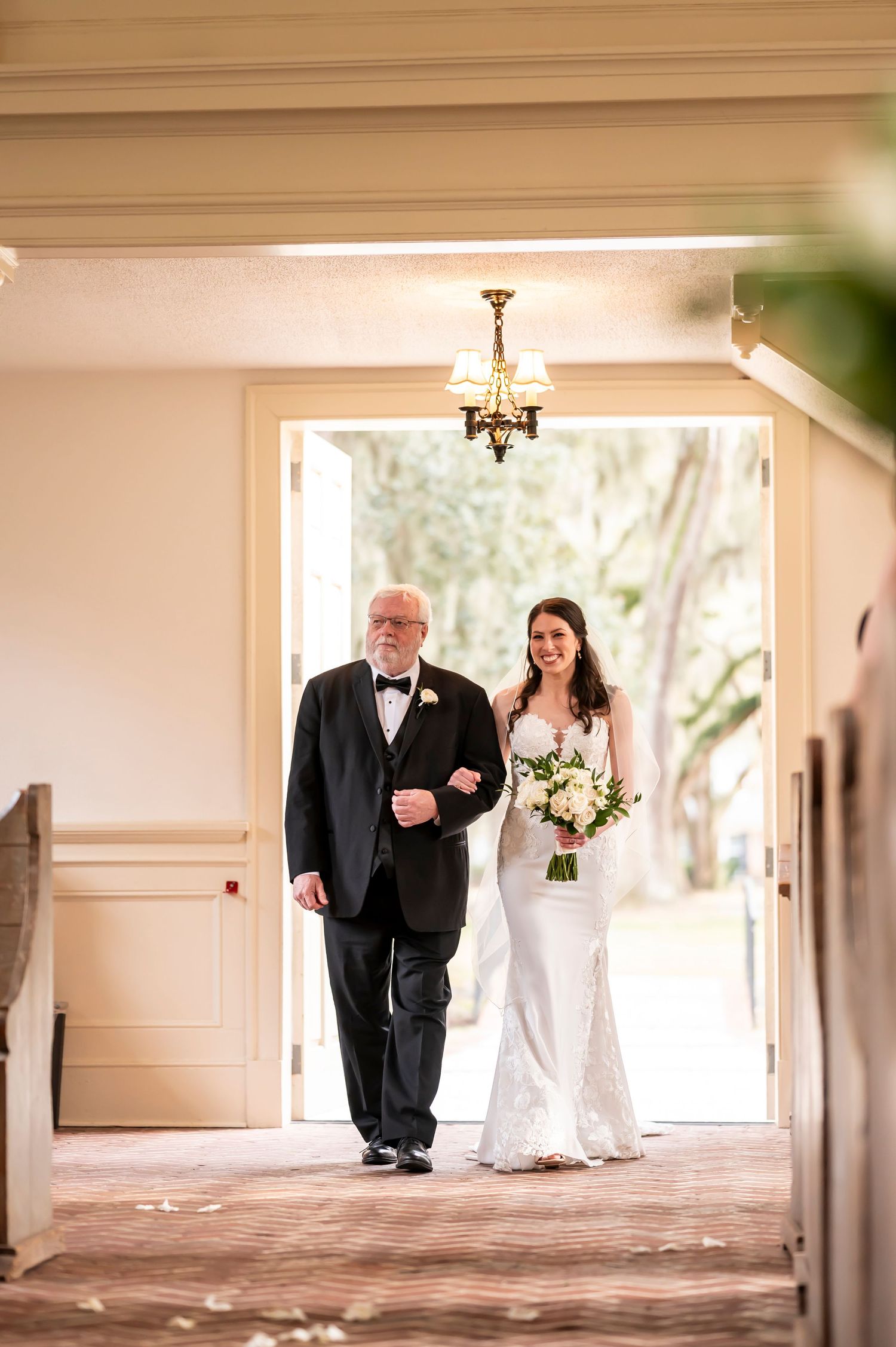 A beautiful sequence of four wedding photos showing a bride and escort walking down a bright hallway.