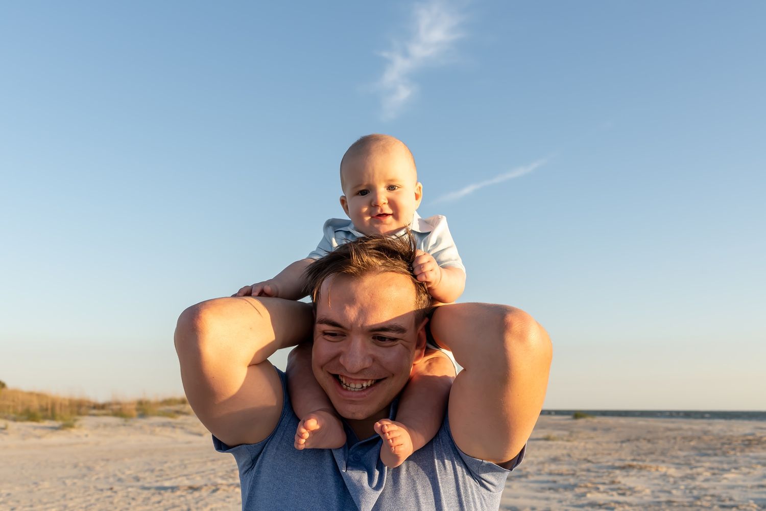 A person enjoys a sunny day at the beach posing in multiple candid shots against a bright blue sky and sand.