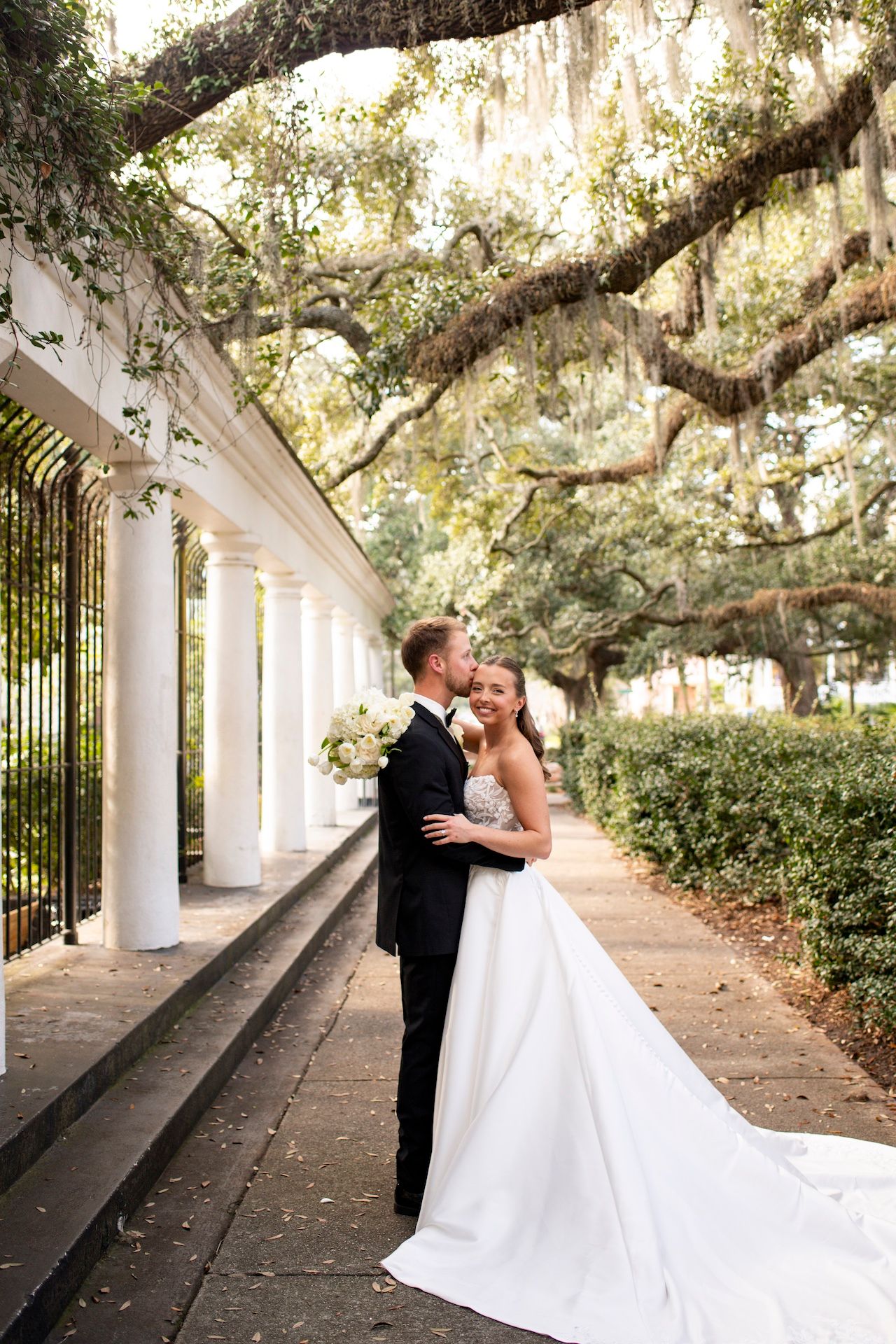 A bride and groom pose outside the Fragrance Garden at Forsyth Park in Savannah, Georgia.