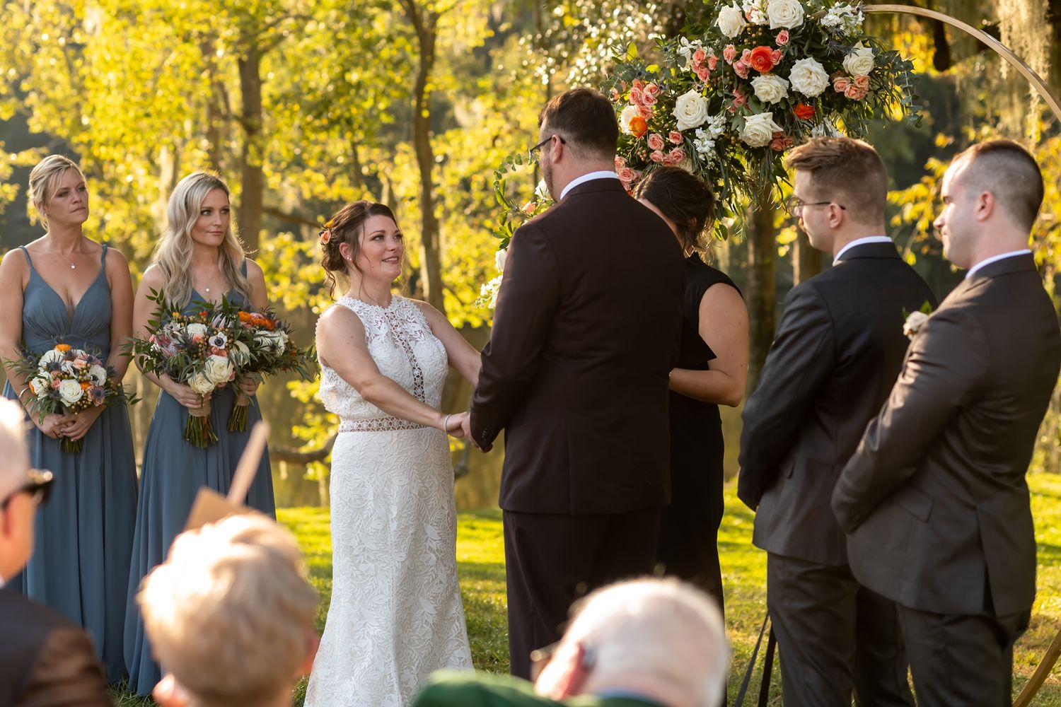 A bride and groom kiss during their outdoor fall wedding ceremony as guests celebrate in multiple candid moments.