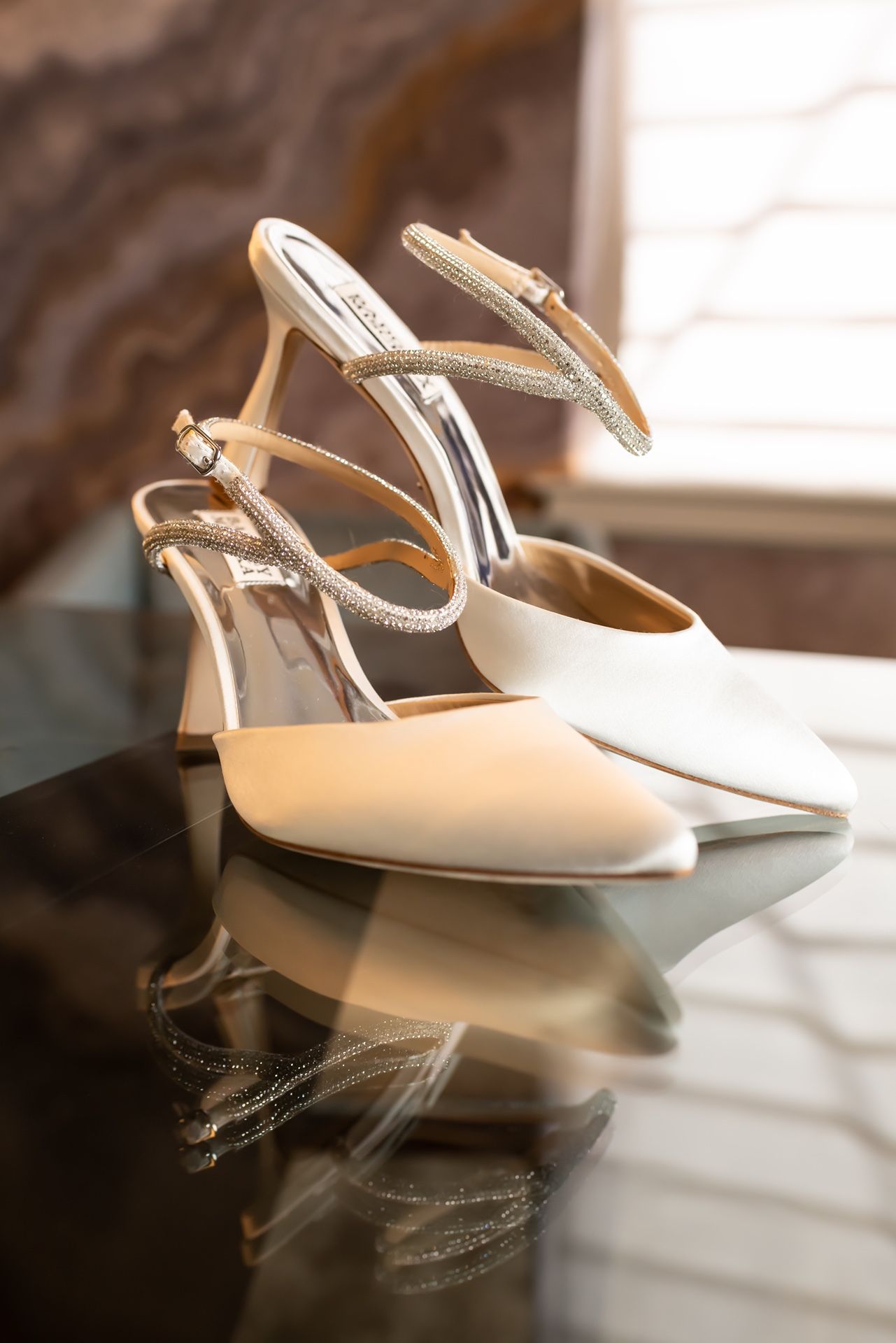 A sequence of elegant cream-colored slingback kitten heel shoes shown from different angles against a white background.