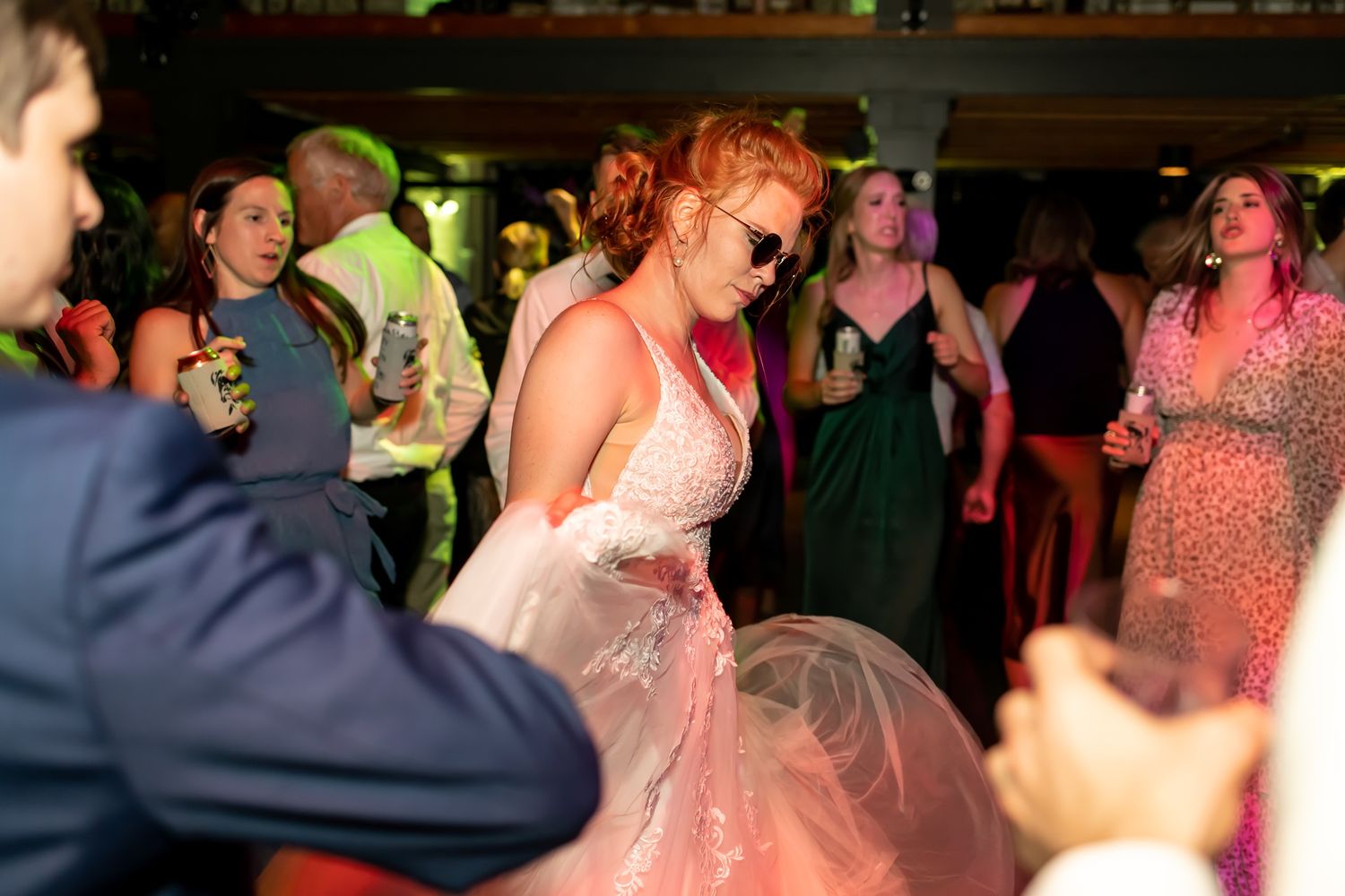 A group of people dancing and enjoying themselves at a nighttime party or celebration.