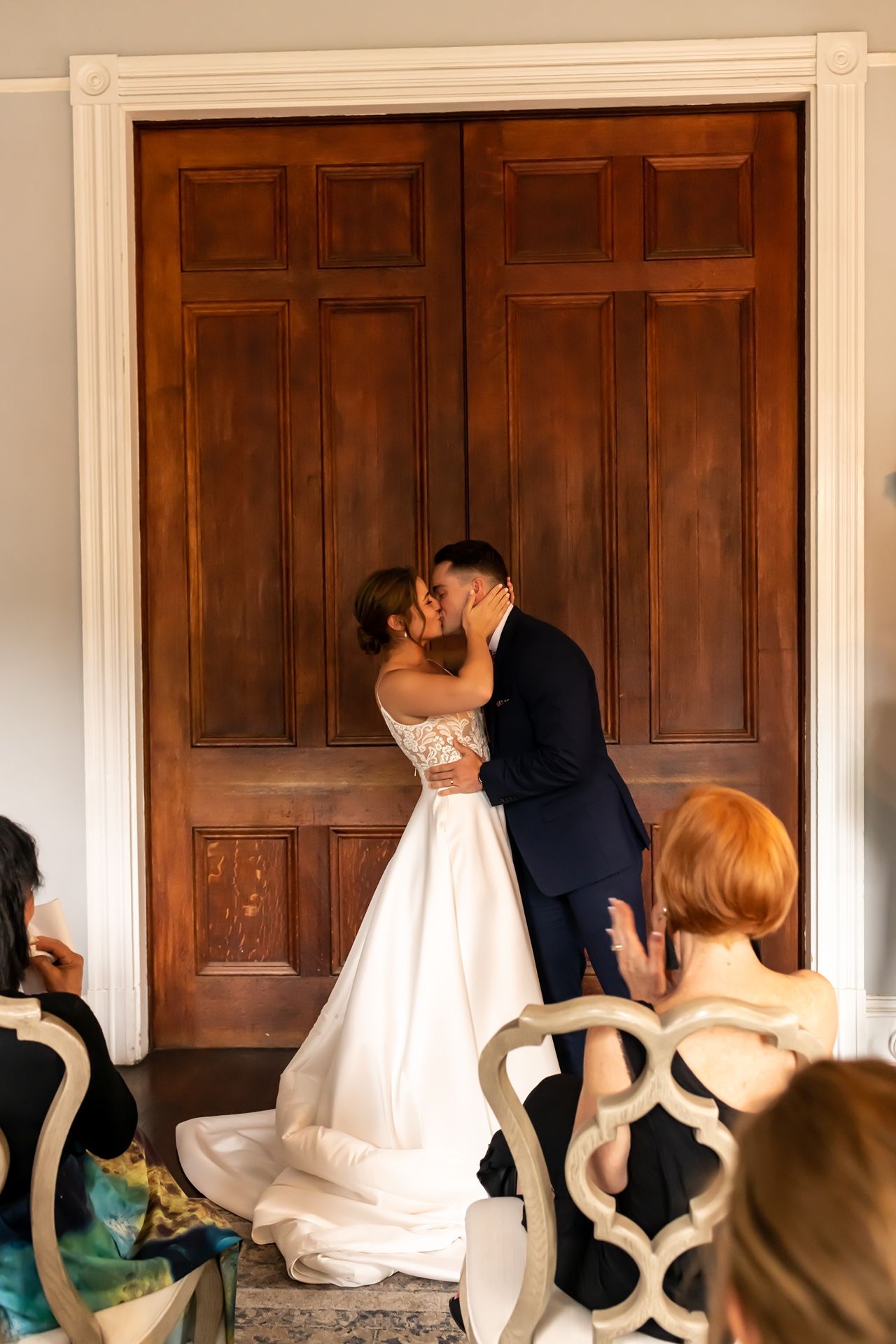 A sequence showing a couple dipping in front of decorative wooden doors during a wedding dance.