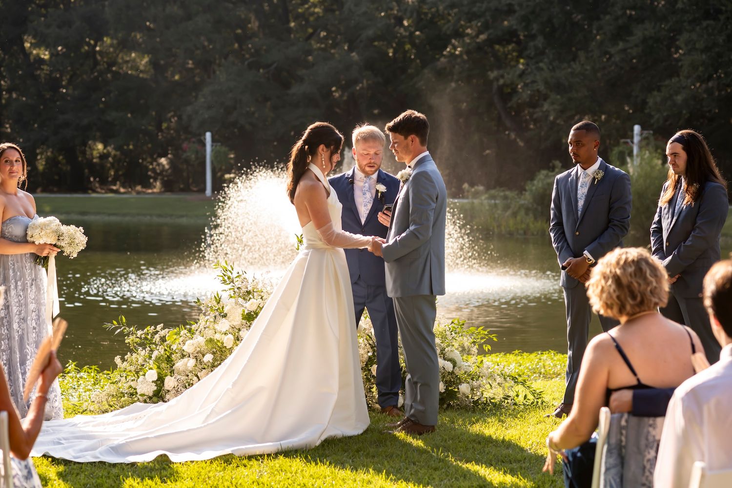 Lakeside wedding ceremony at The Mackey House overlooking the fountain.