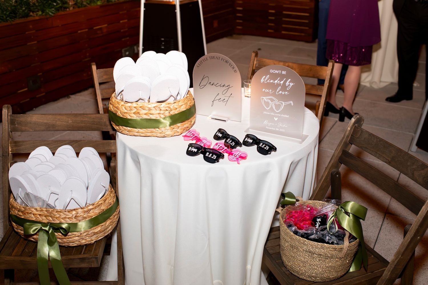 A rustic wedding reception setup with wooden decor, candles, and white floral arrangements on tables.