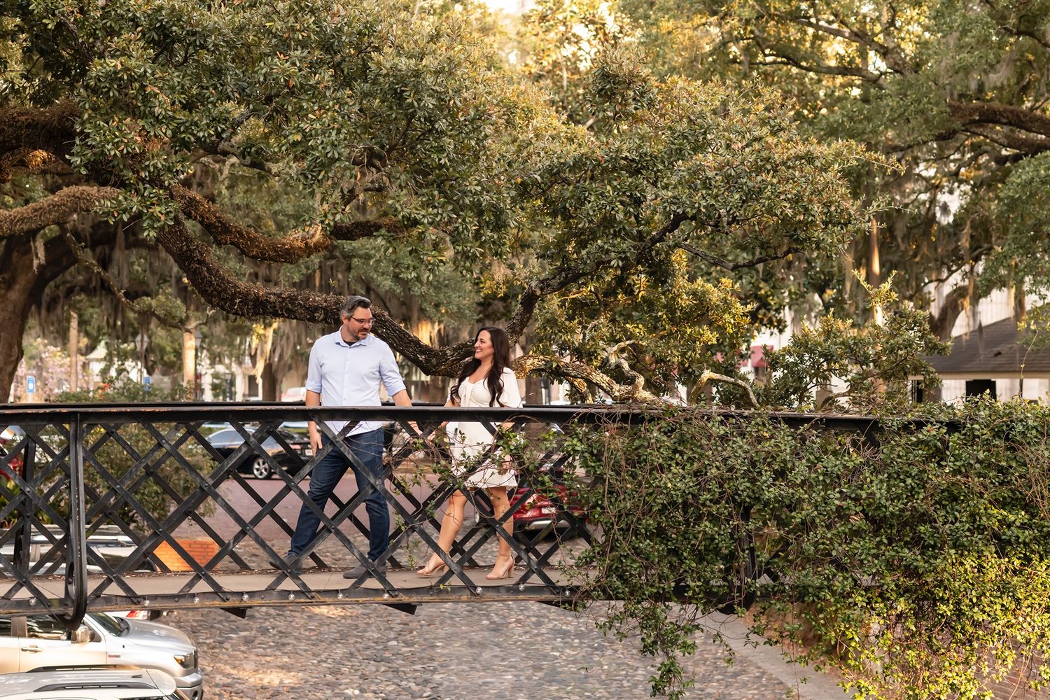 A sequence of outdoor wedding ceremony setups among trees with white folding chairs at golden hour.
