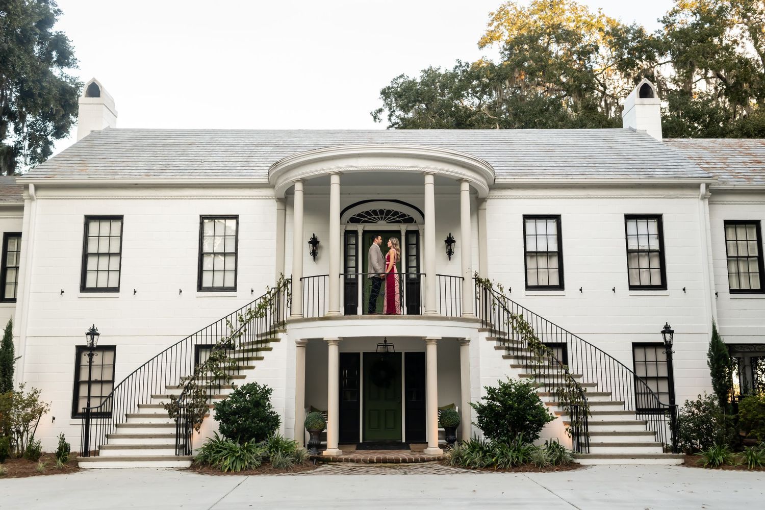 A series of white colonial style buildings with curved staircases and large windows showcased in a horizontal collage.