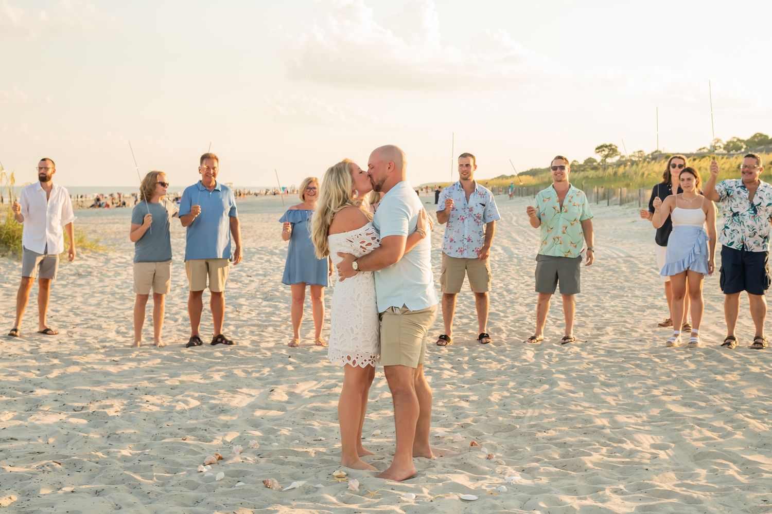 A series of beachfront proposal moments photographed at sunset capturing joyful celebrations in the sand.