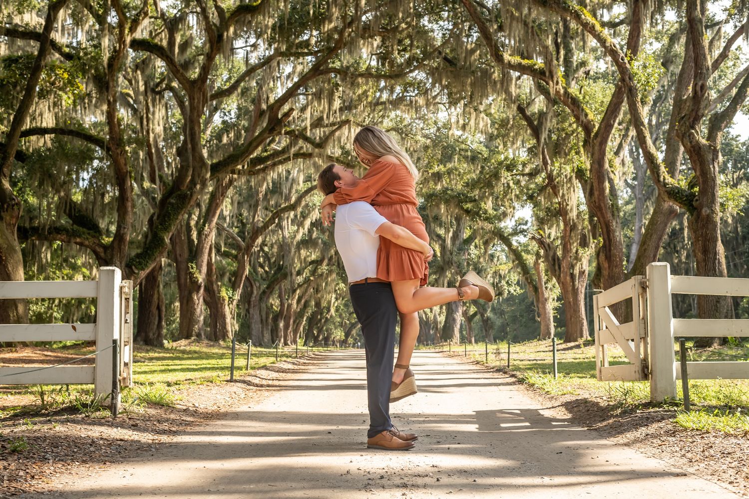 Couple walking down a tree-lined path with Spanish moss and white fence, captured in multiple photography frames.
