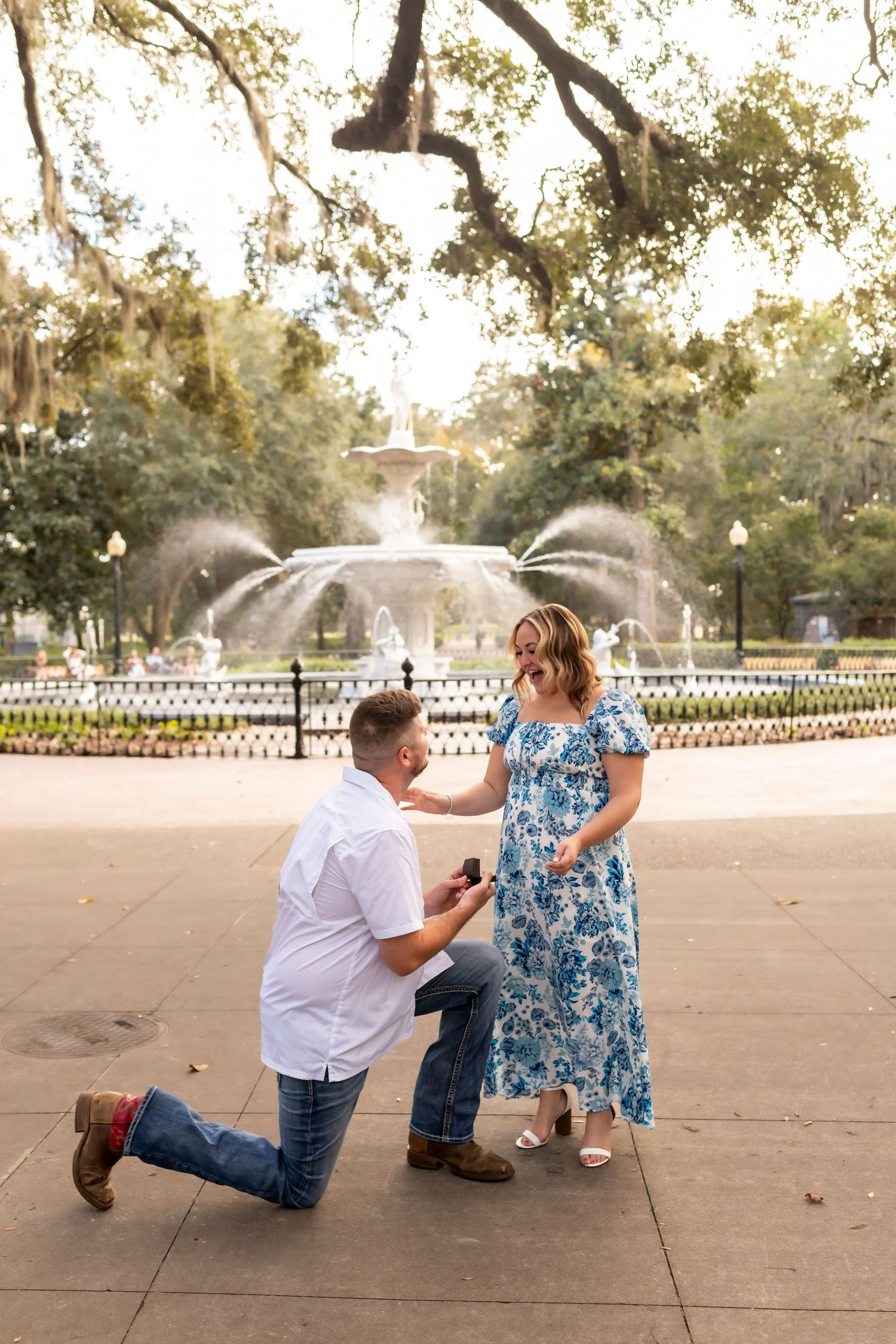 Proposal photographer capturing a surprise engagement at Forsyth Park in Savannah