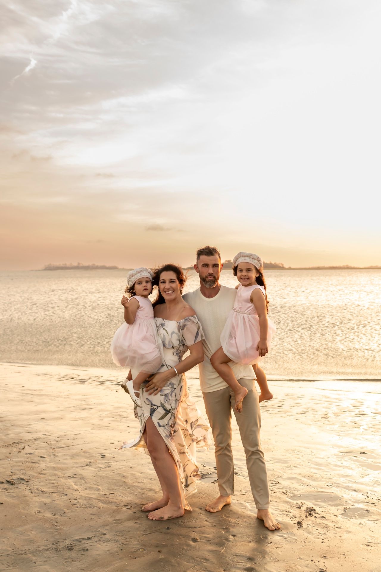 A joyful family photo session on a beautiful beach at sunset.