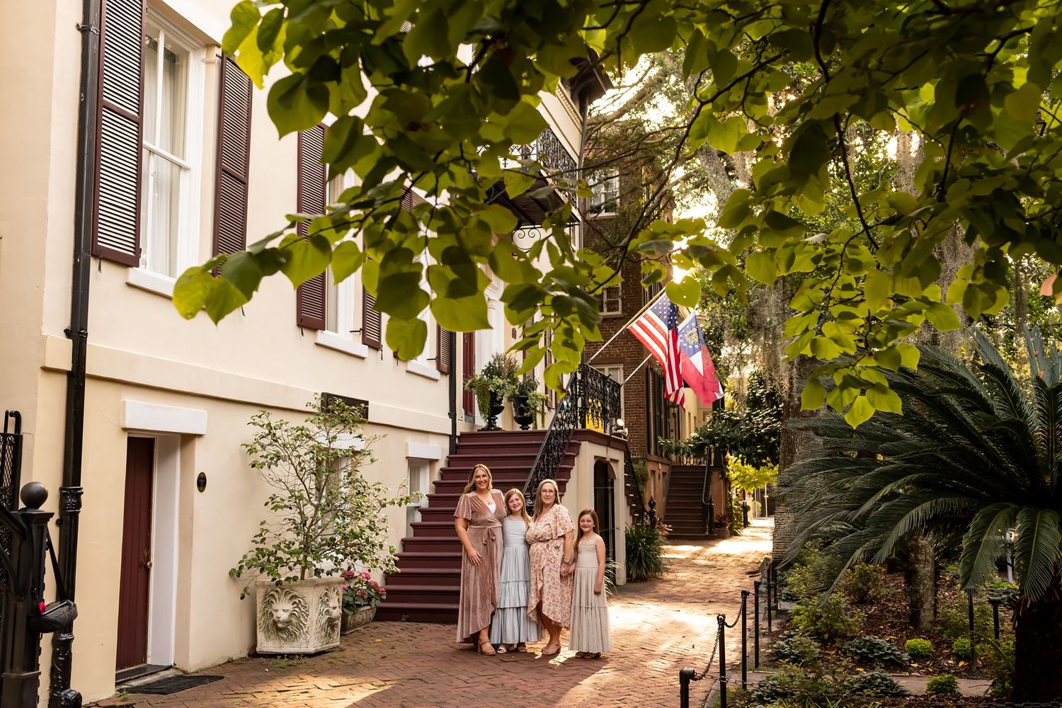 Historic brick walkway with autumn leaves and colonial style buildings in Charleston's historic district.