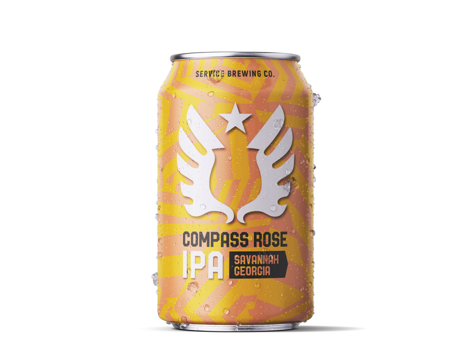 A gold and orange can of Compass Rose IPA craft beer with a winged pineapple logo design against a white background.