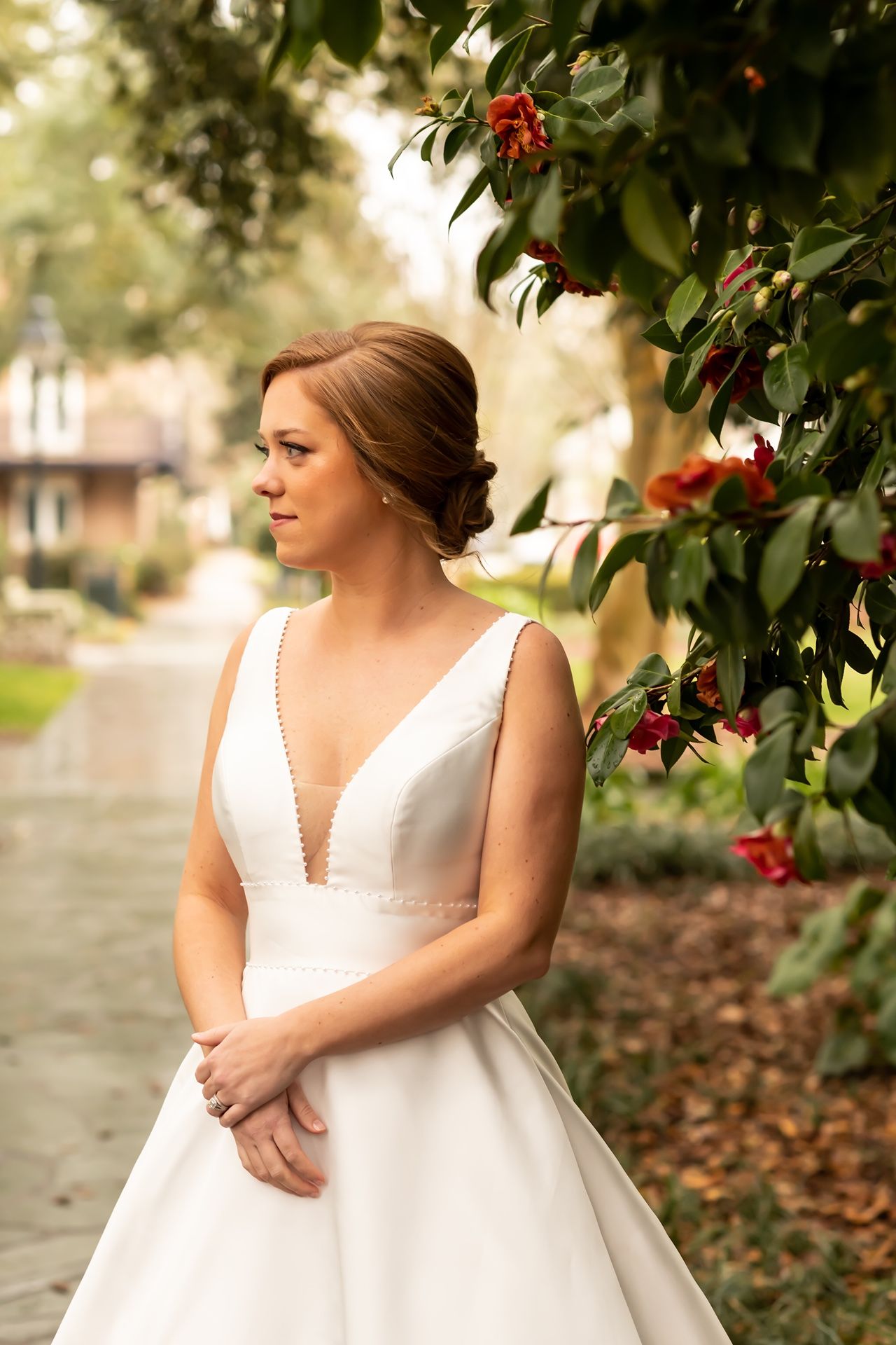 Scenic bridal portraits in an outdoor autumn setting with vibrant red berries and fallen leaves.