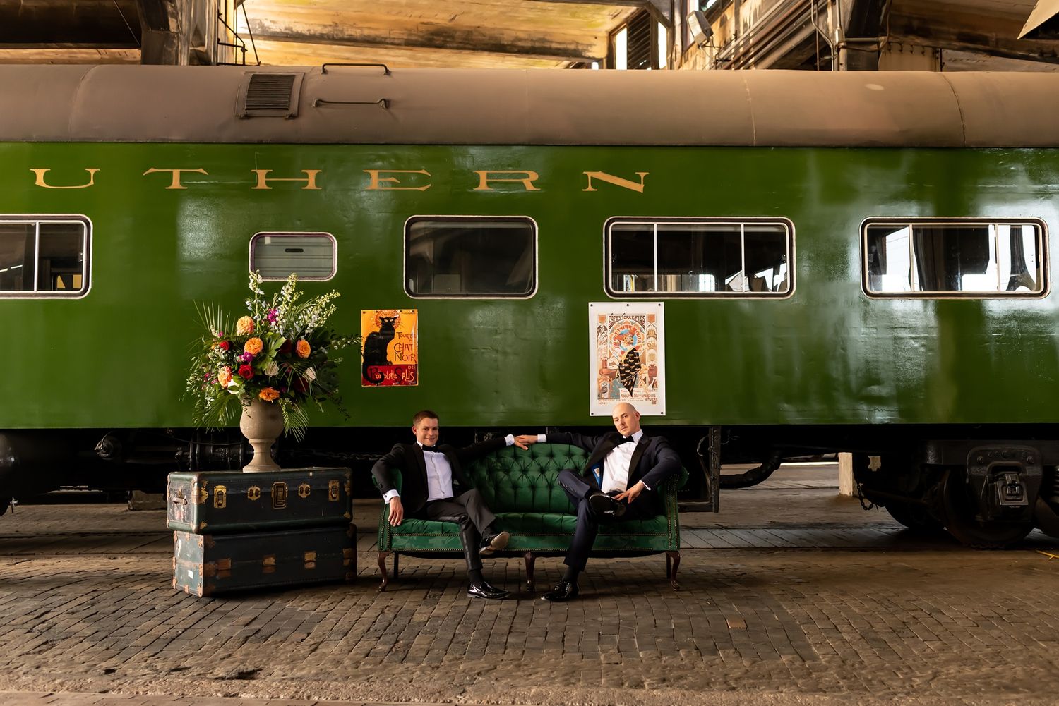 A row of vintage green train carriages sit on railway tracks, creating a nostalgic transportation scene.