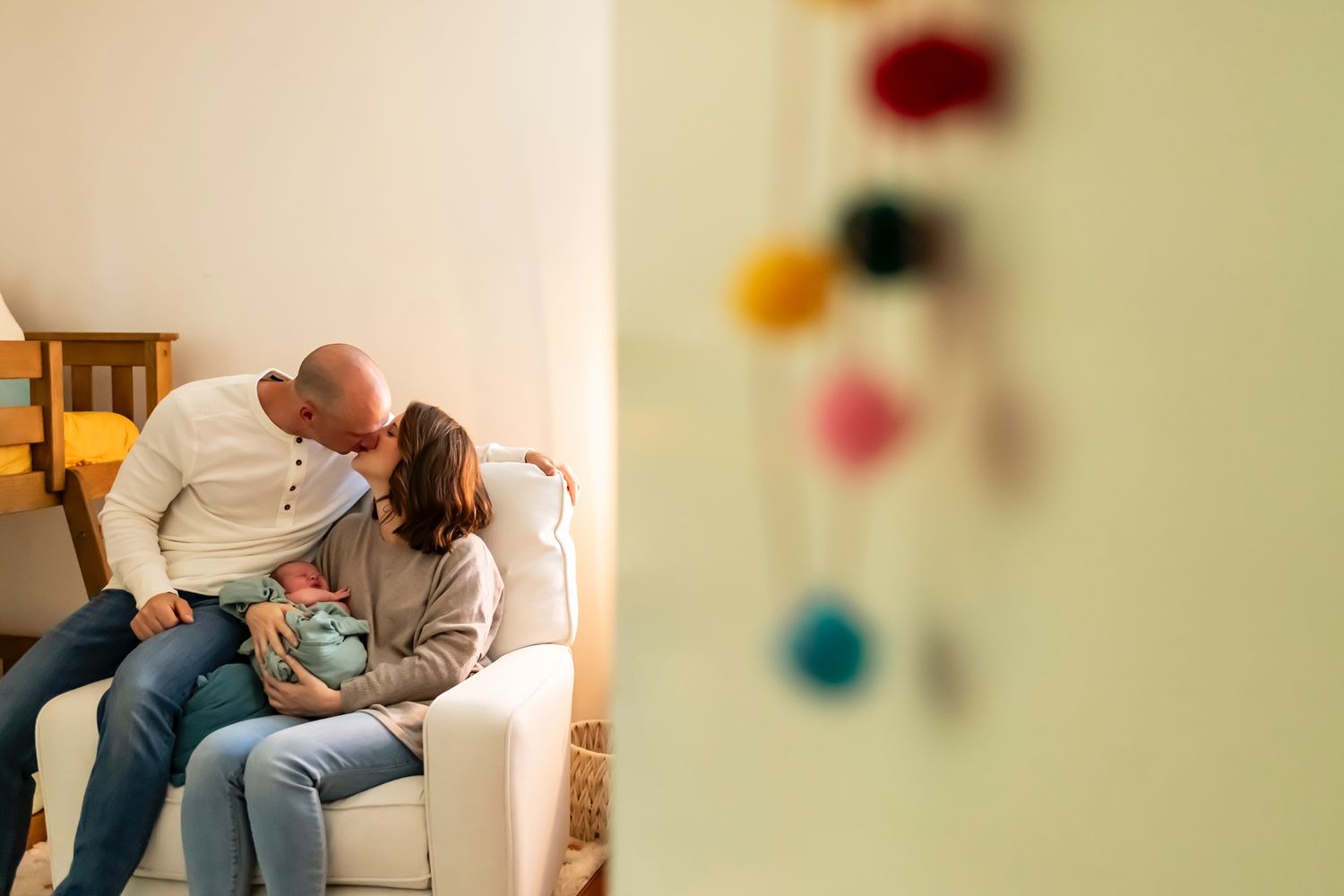 A series of tender moments between parent and newborn shows intimate bonding in a softly lit home setting.