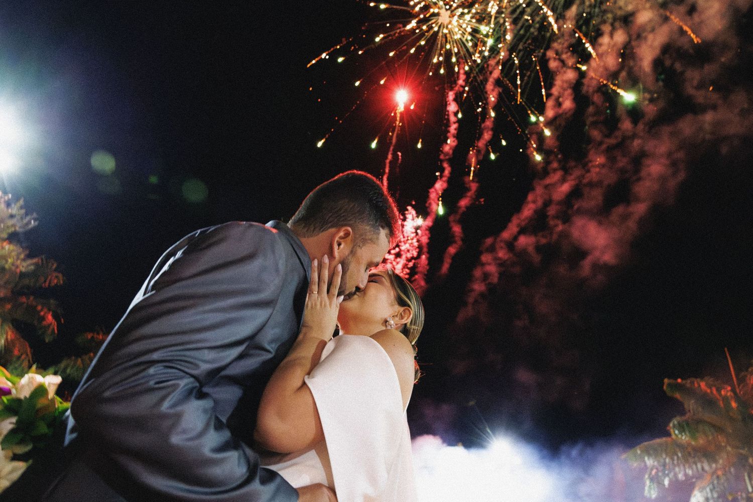 Vibrant fireworks bursting in the night sky during a celebration.