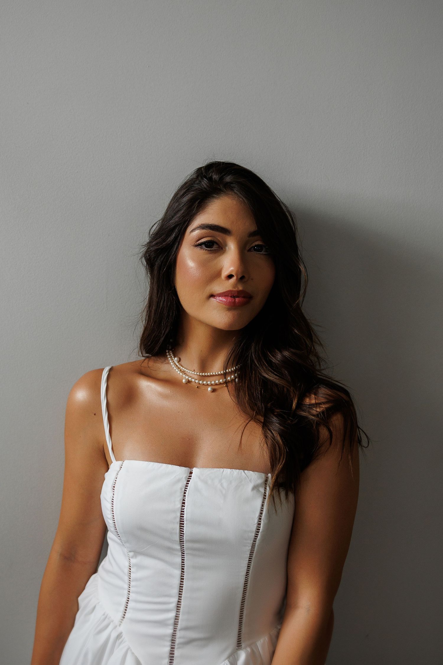 Portrait series in white against a grey backdrop with elegant styling.
