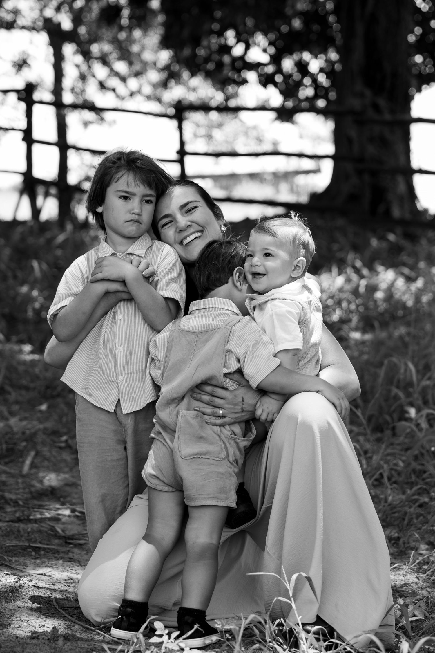 Black and white portrait of siblings sharing sweet moments outdoors.