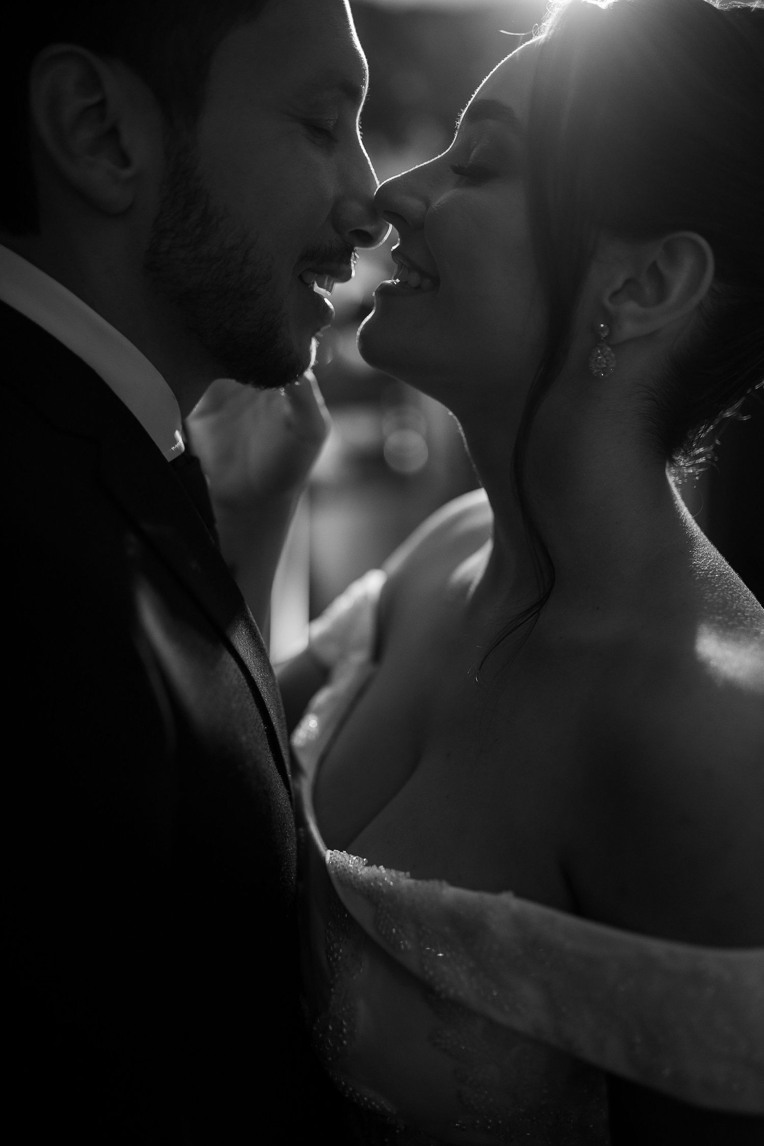 Intimate black and white portrait of a couple sharing a romantic moment.