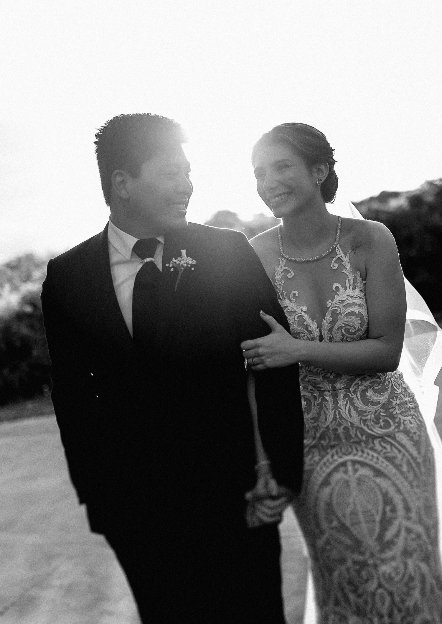 Artistic wedding photos captured in bright sunlight showing intimate moments between newlyweds.