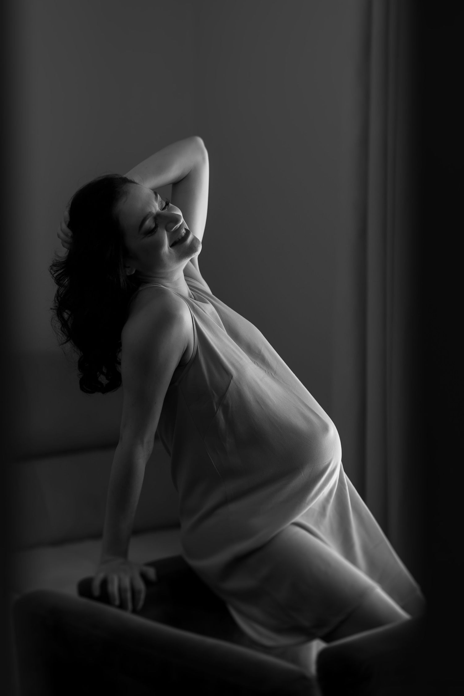 Artistic black and white photos showing graceful movement in dramatic lighting.