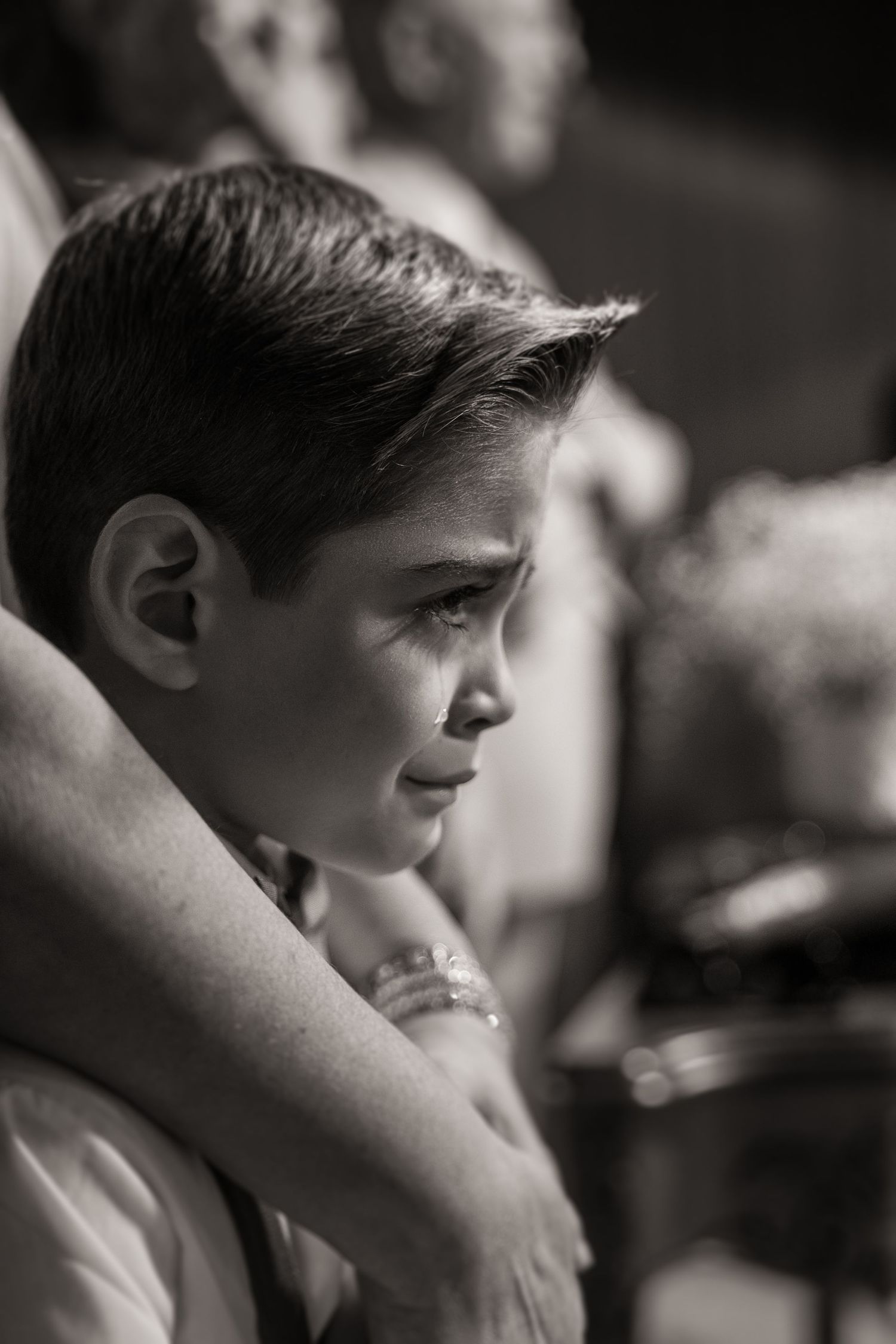 A candid black and white profile portrait captures a tender moment.