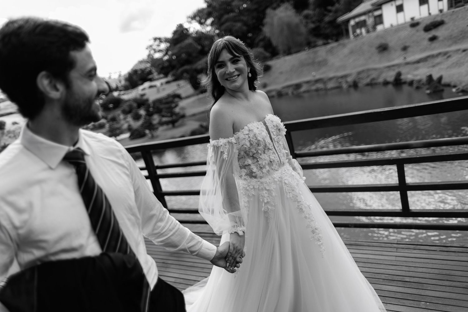 Black and white wedding portraits in a rustic outdoor setting.