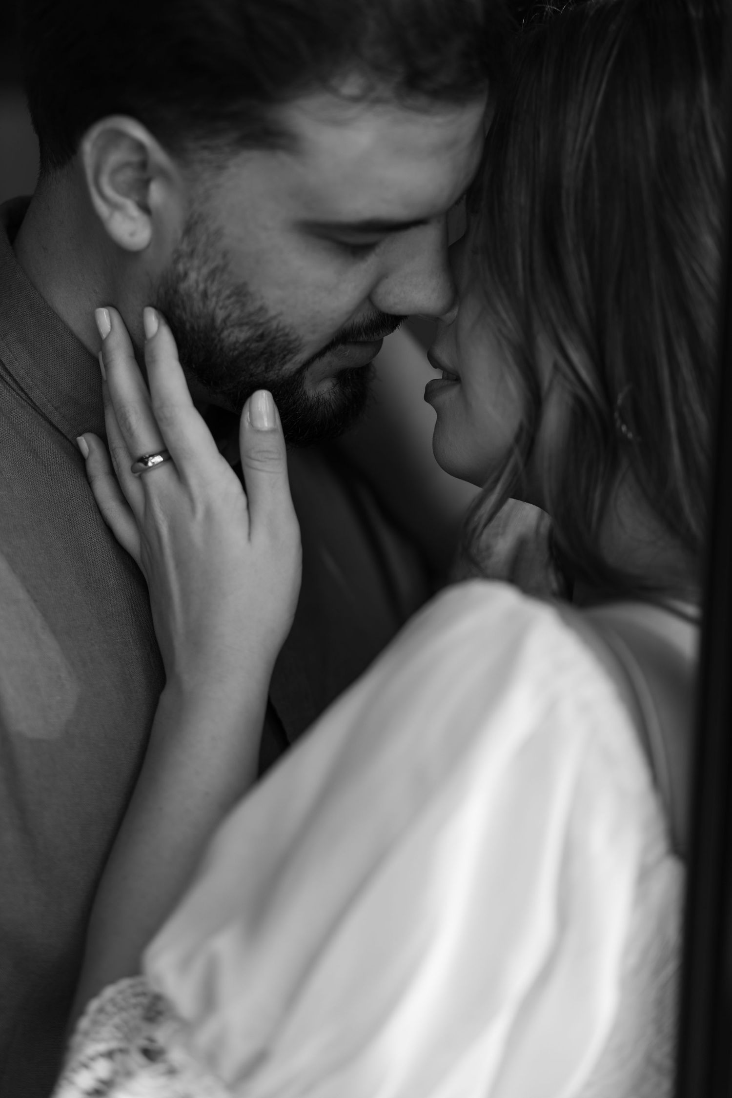 Intimate black and white portrait capturing tender moments between a couple.