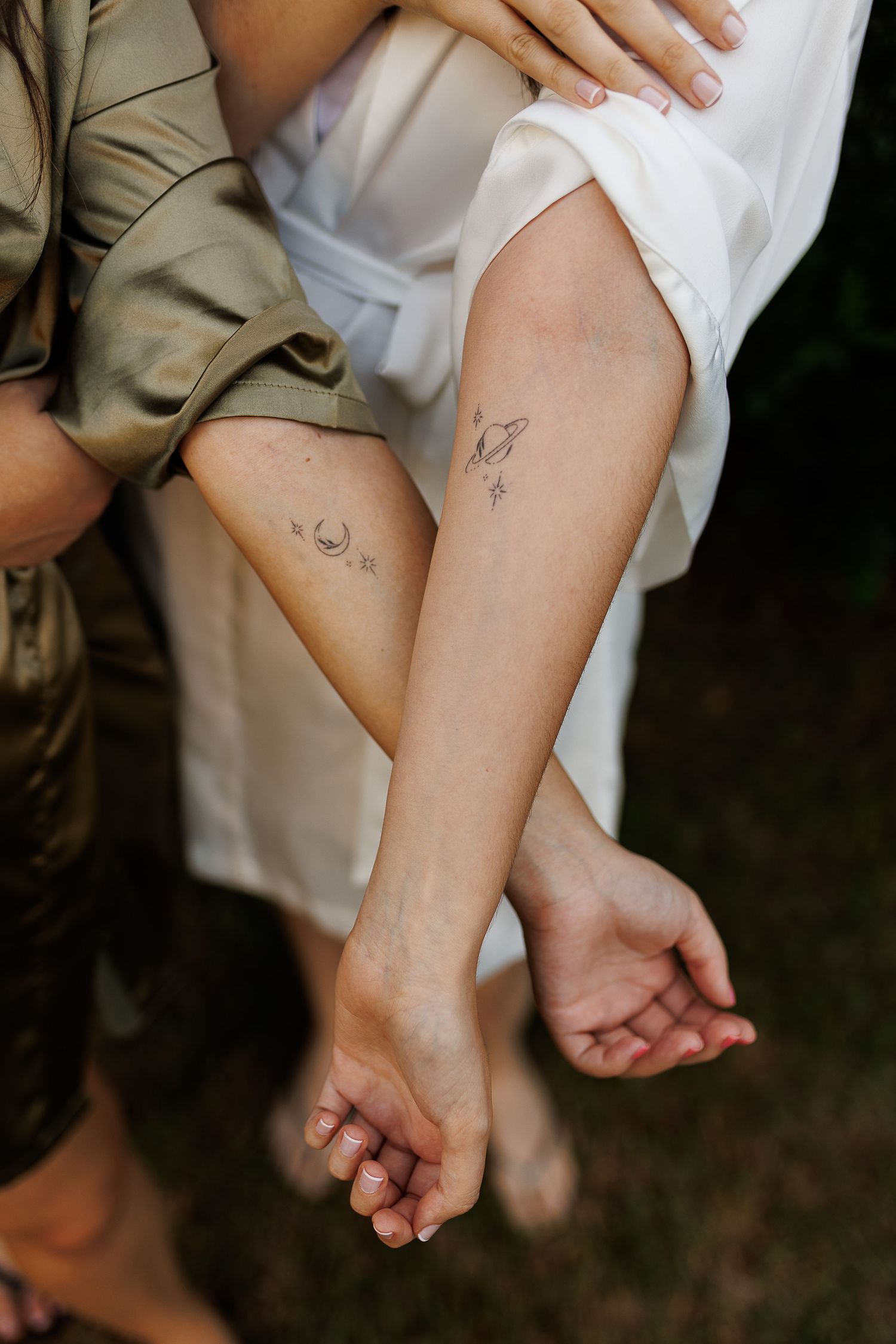 Close-up detail shot of matching tattoos on ankles.